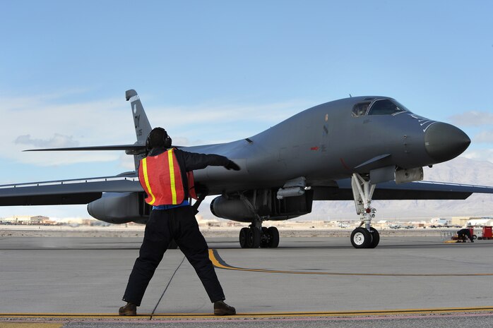 NELLIS AIR FORCE BASE, Nev. -- Staff Sgt. Jose Sanchez, crew chief assigned to the 7th Aircraft Maintenance Squadron, marshals a B-1 bomber during Red Flag 10-3, March 5, 2010.  Red Flag is a realistic combat training exercise involving the air forces of the United States and its allies. The exercise is conducted on the 15,000-square-mile Nevada Test and Training Range north of Nellis. (U.S. Air Force photo by Lawrence Crespo/RELEASED)