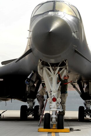 NELLIS AIR FORCE BASE, Nev. --  Crew chiefs assigned to the 7th Aircraft Maintenance Squadron, install safety pins on the front landing gear of a B-1 bomber during Red Flag 10-3, February 26, 2010.  Red Flag is a realistic combat training exercise involving the United States Air Force and its allies. The exercise is conducted on the 15,000-square-mile Nevada Test and Training Range, north of Las Vegas. (U.S. Air Force photo by Lawrence Crespo/RELEASED)