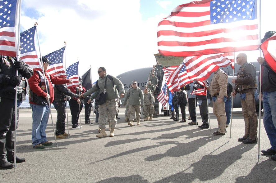 FAIRCHILD AIR FORCE BASE, Wash.--A member of the 141st Security Forces Flight walks through the cordon of greeters from the Patriot Guard here Feb. 25. (U.S. Air Force photo / SSgt Chad Watkins)