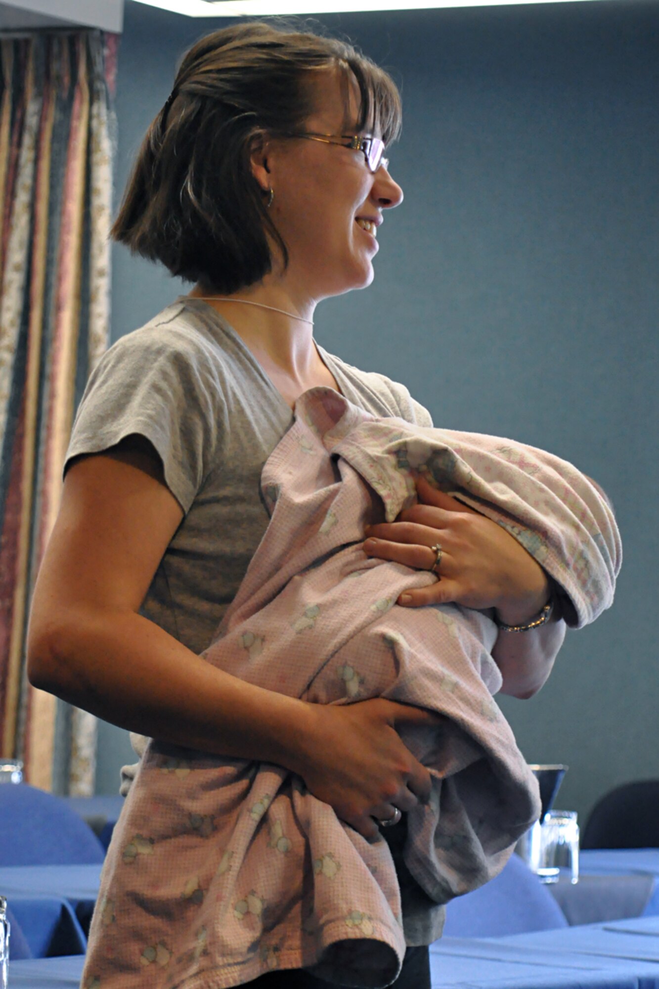 Mary Tipton, spouse and Yellow Ribbon participant, holds her baby while listening to Chaplain (Maj.) Derek Guinn discuss the challenges of deployment and marriage at the Cliff Lodge in the Snowbird Ski and Summer Resort. (U.S. Air Force photo/Staff Sgt. Heather Skinkle)
