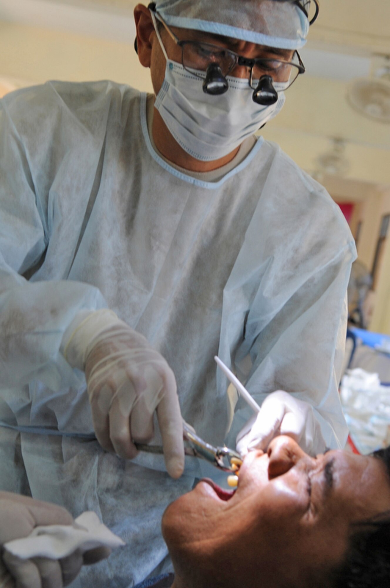 A local man has a tooth extracted by Maj. (Dr.) Kurt Nishiguchi March 4, 2010, at Bau Nong Sroung School in Thailand. Doctor Nishiguchi is an Air Force reservist from Joint Base Pearl Harbor-Hickam, Hawaii. (U.S. Air Force photo/Tech. Sgt. Cohen A. Young)