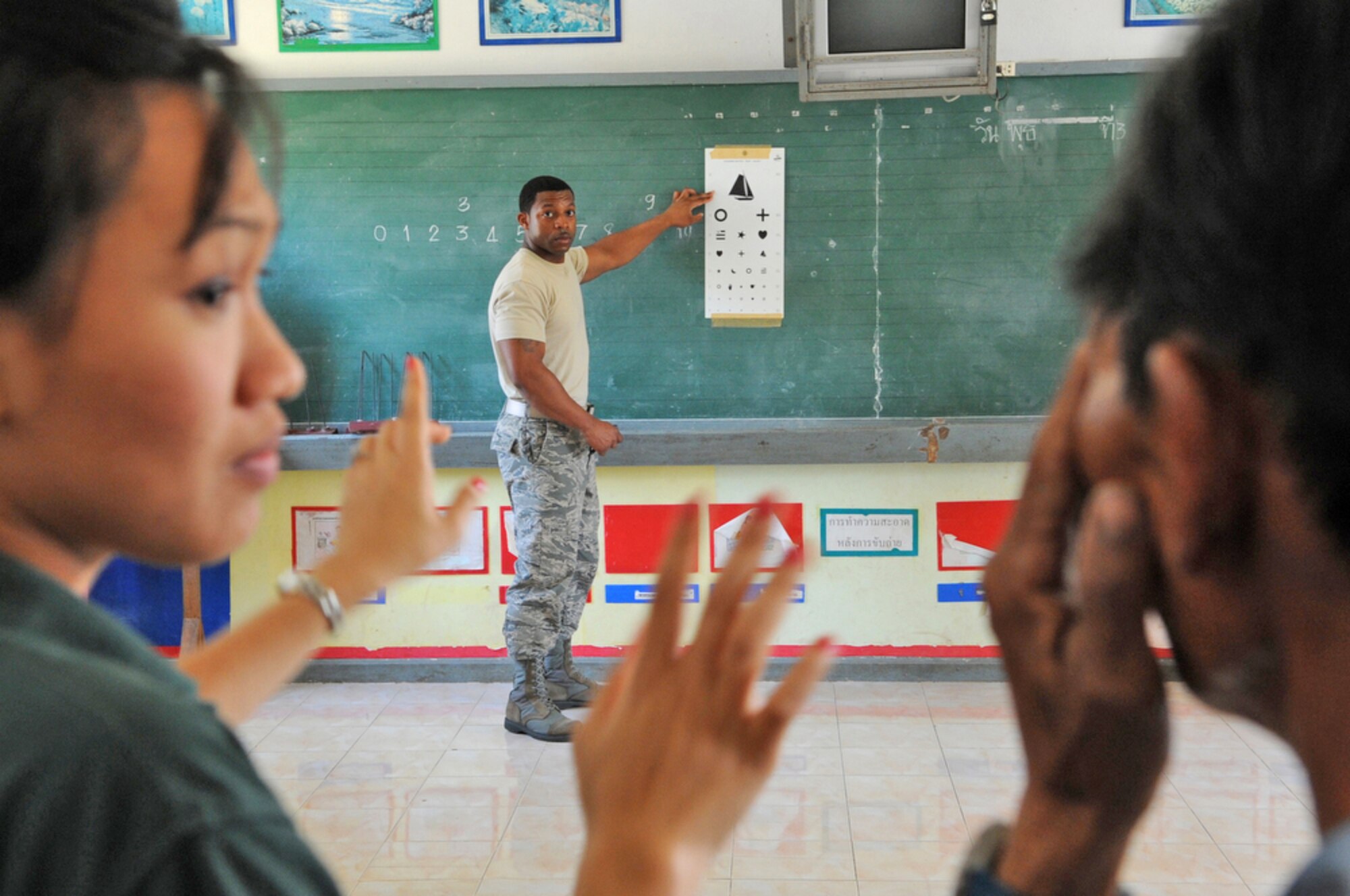 Staff Sgt. Destin Huey conducts an eye exam during a Cope Tiger 2010 community relations event March 4, 2010, at Bau Nong Sroung School in Thailand. Sergeant Huey is assigned to the 18th Medical Group at Kadena Air Base, Japan. (U.S. Air Force photo/Tech. Sgt. Cohen A. Young)