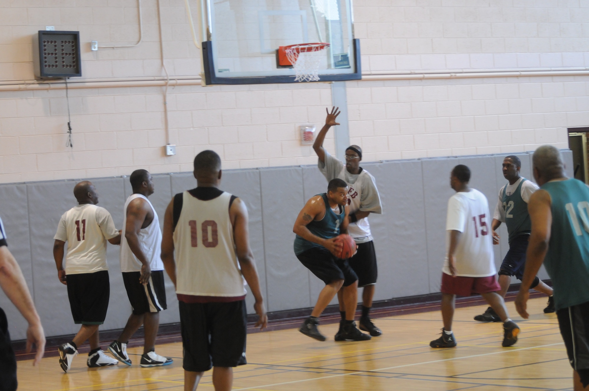 The 21st Force Support Squadron's Anthony Hill defends Air Force Operation and Test Evaluation Center's Mike Chandler during first half action of the Over-30 championship game Feb. 18 at the Peterson Sports and Fitness Center. (U.S. Air Force photo/Walt Johnson)