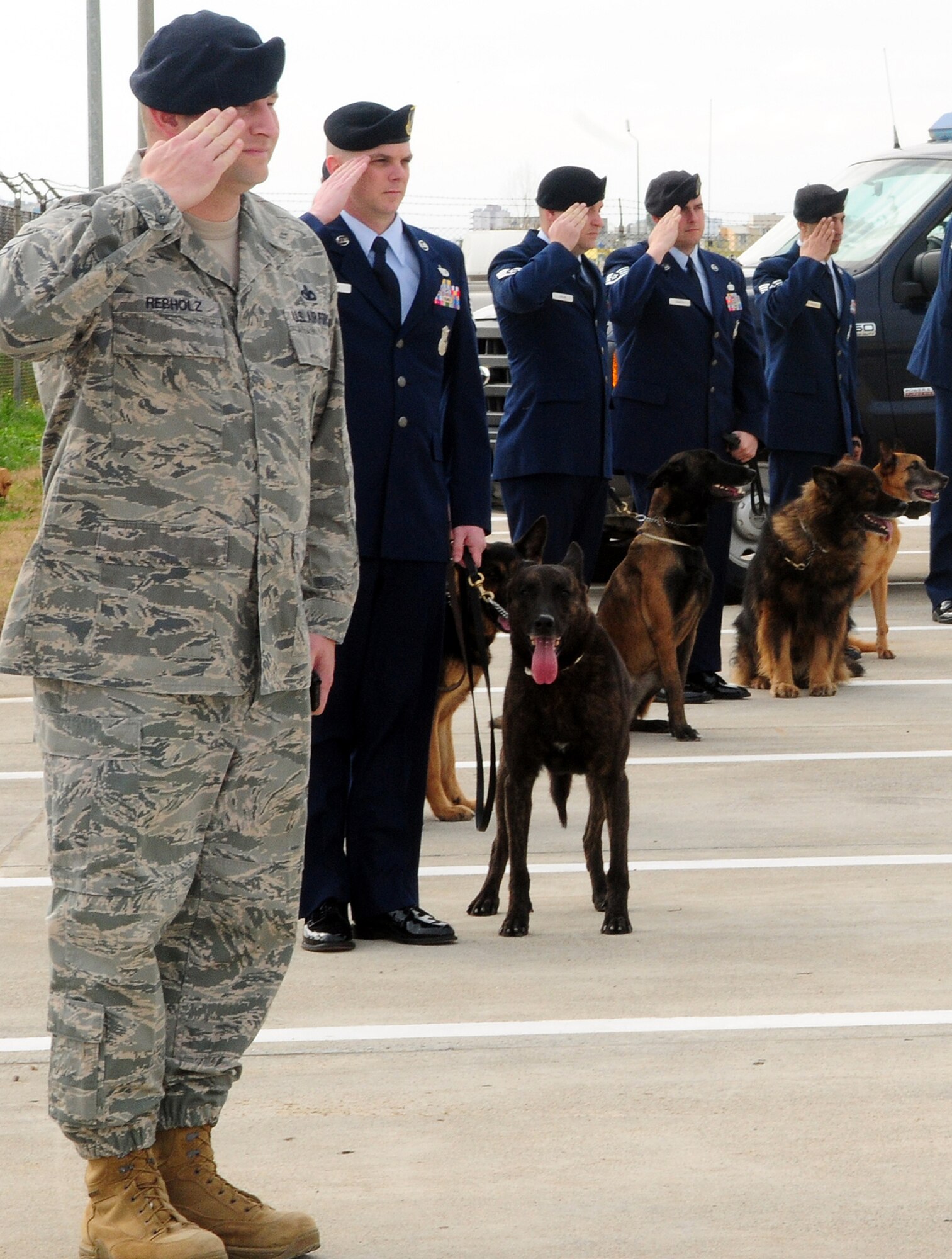 39th Security Forces Squadron military working dog handlers salute during the playing of the national anthem during a memorial service in honor of Ronnie, a fallen MWD Feb. 25, 2010, at Incirlik Air Base, Turkey. (U.S. Air Force Photo/Senior Airman Alex Martinez)