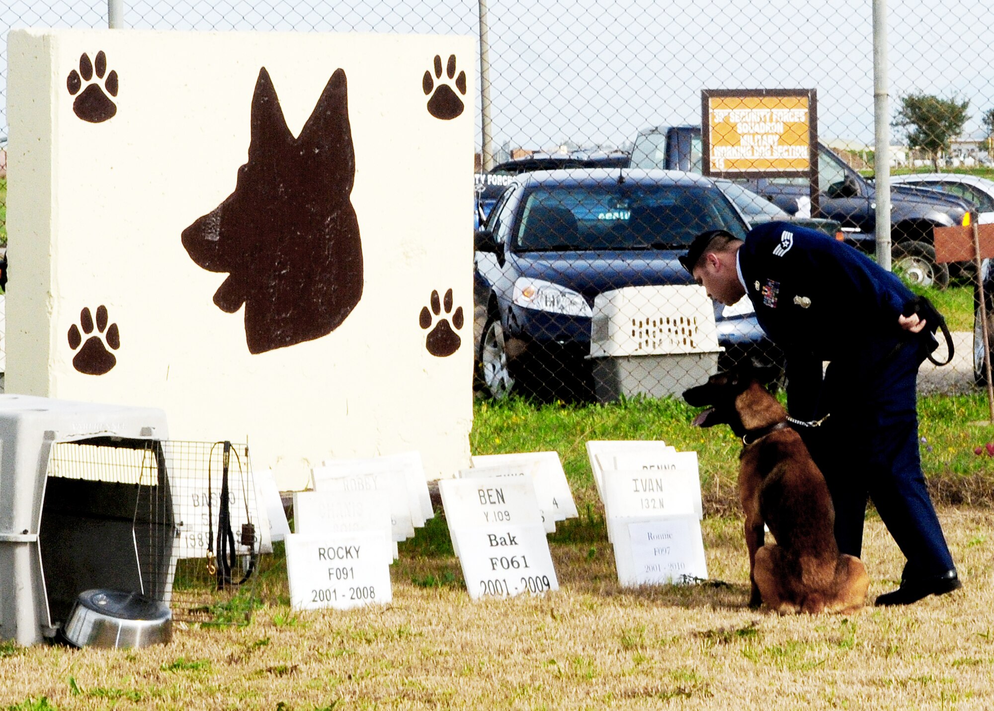 Staff Sgt. Frederick Thiessen lays flowers in front of a plaque dedicated to Ronnie, a fallen 39th Security Forces Squadron military working dog, during his memorial ceremony Feb. 25, 2010, at Incirlik Air Base, Turkey. Sergeant Thiessen is a military working dog handler assigned to the 39th Security Forces Squadron. (U.S. Air Force photo/Senior Airman Alex Martinez)