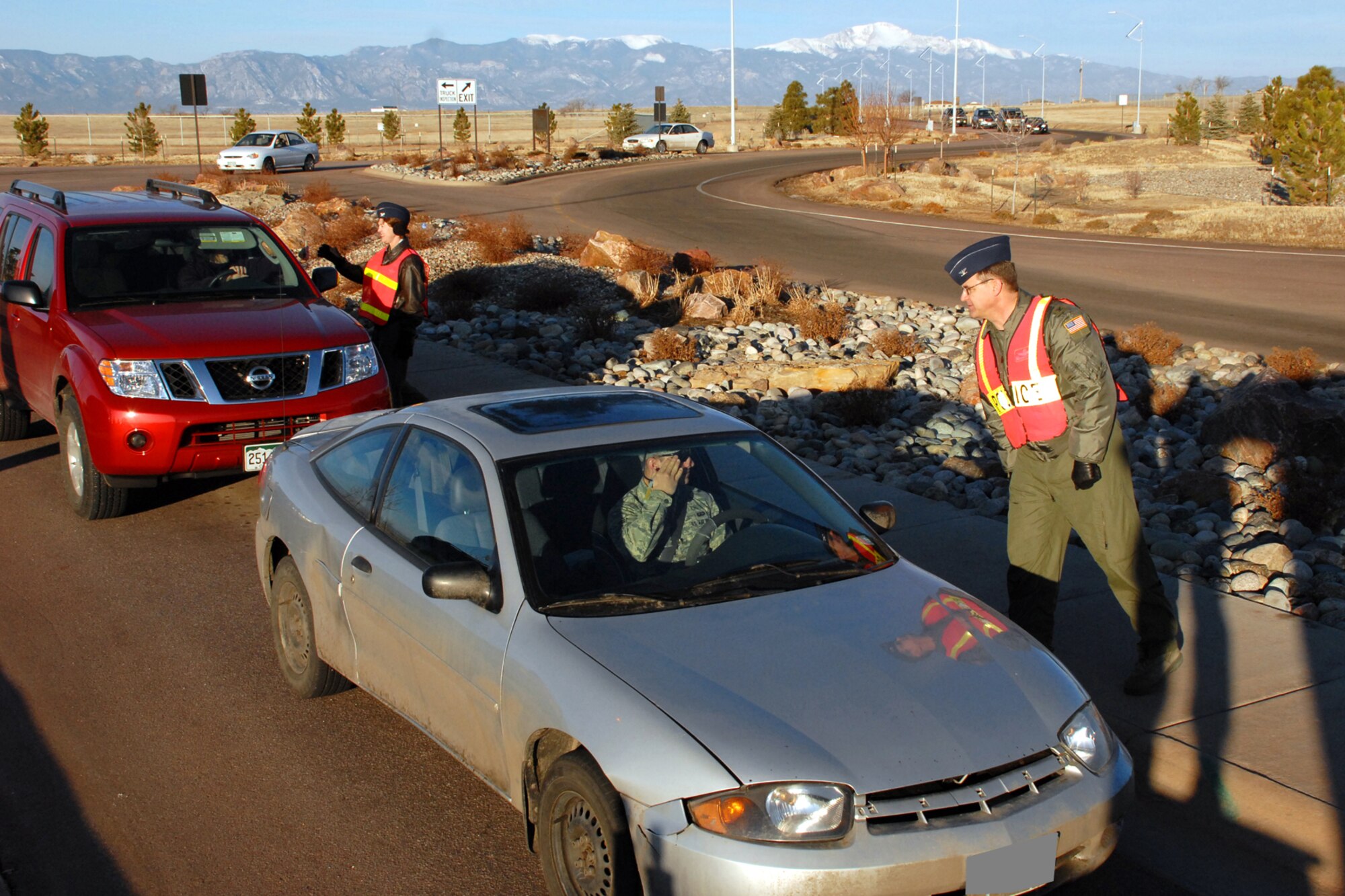 SCHRIEVER AIR FORCE BASE, Colo. -- Col. Karen Rizzuti, 310th Space Wing commander, and Col. Kevin Cavanagh, 310th Operations Group commander, check Schriever personnel ID cards while performing gate guard duty March 3.  Mission partner commanders were on hand to perform the security detail and welcome Schriever personnel on base.  (U.S. Air Force photo/Staff Sgt. Daniel Martinez)