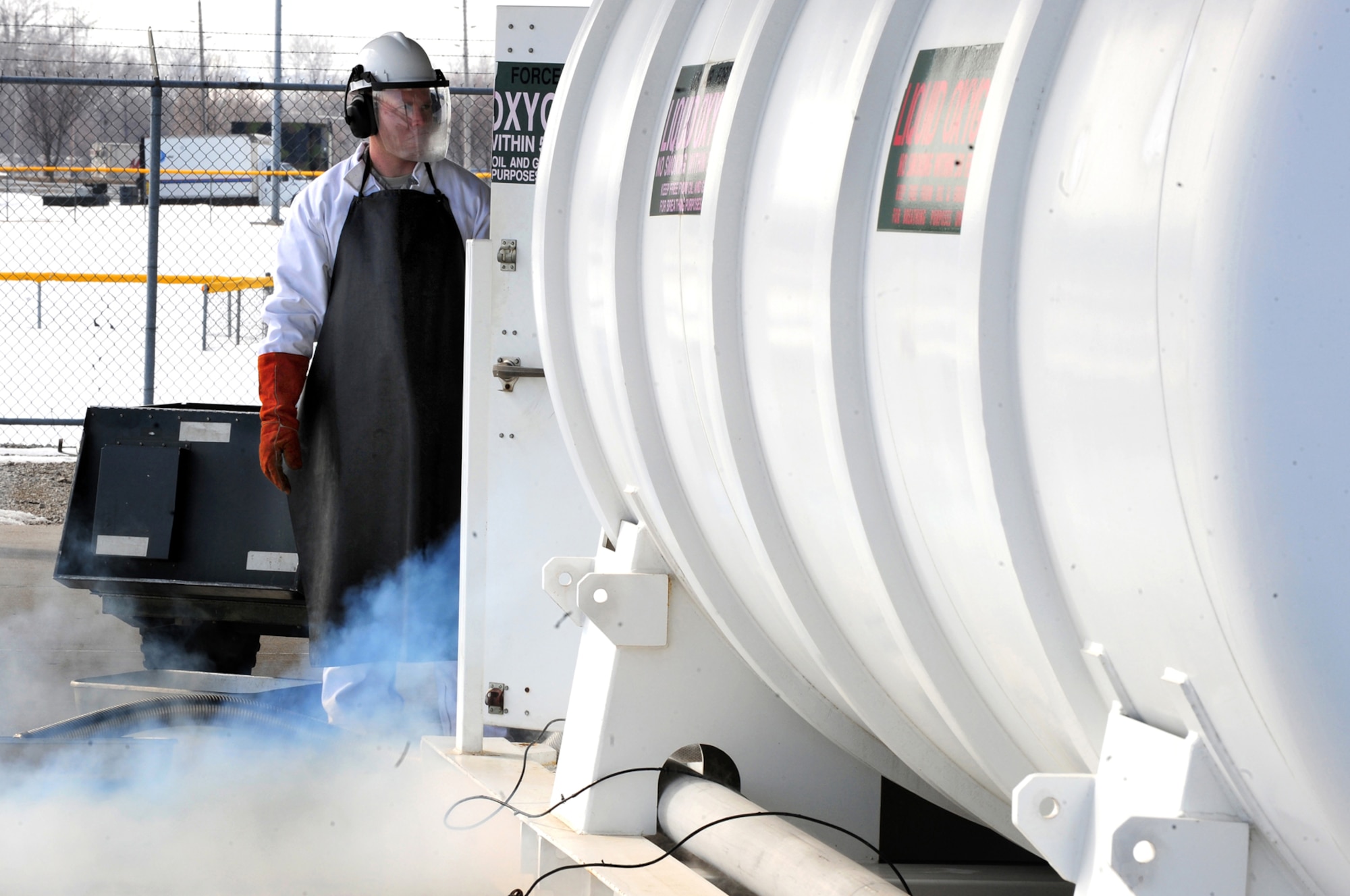 OFFUTT AIR FORCE BASE, Neb. - Senior Airman Nicholas Simon, a fuels facilities technician with the 55th Maintenance Squadron's Fuels Management Flight, purges a hose attached to a liquid oxygen tank in order to remove impurities prior to filling a portable oxygen cart here March 2. Airmen of the flight are responsible for the bulk storage and distribution of liquid oxygen, or LOX. U.S. Air Force photo by Josh Plueger
