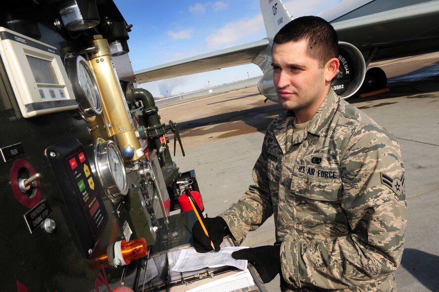 OFFUTT AIR FORCE BASE, Neb. - Airman 1st Class Ricky Vickers, a fuels distribution operator with the 55th Maintenance Squadron's Fuels Management Flight, annotates the amount of fuel issued to refuel a Constant Phoenix aircraft  on Offutt's flightline March 1. In 2009, Airmen assigned to the flight delivered about 18 million gallons of JP-8 fuel to customers. U.S. Air Force photo by Josh Plueger