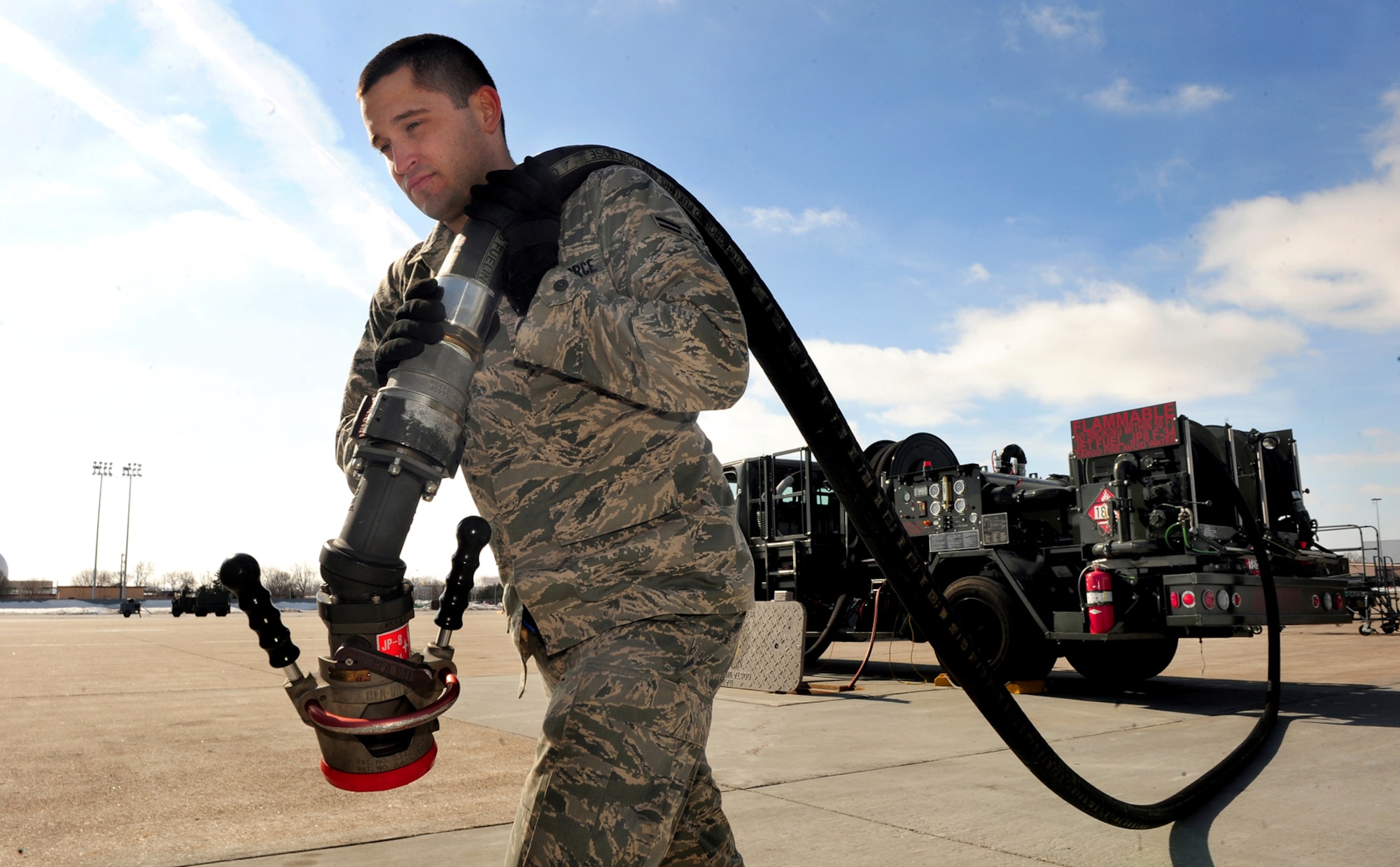 OFFUTT AIR FORCE BASE, Neb. - Airman 1st Class Ricky Vickers, a fuels distribution operator with the 55th Maintenance Squadron's Fuels Management Flight, prepares to refuel a 55th Wing Constant Phoenix aircraft here using the underground fuel delivery system and an R-12 hydrant truck March 1. The R-12 is capable of pushing up to 1,000 gallons of jet fuel per minute. U.S. Air Force photo by Josh Plueger
