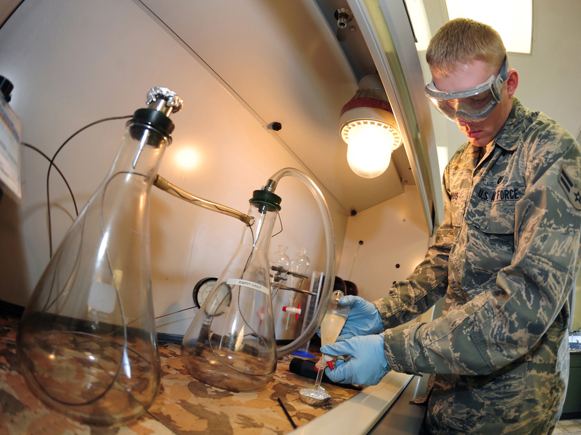OFFUTT AIR FORCE BASE, Neb. - Airman 1st Class Edward Damhuis, a fuels labratory technician, performs tests in the Fuels Management Flight's fuels information center laboratory here March 1. The laboratory tests fuel for various things including the level of Fuel System Ice Inhibitor additive. U.S. Air Force photo by Josh Plueger
