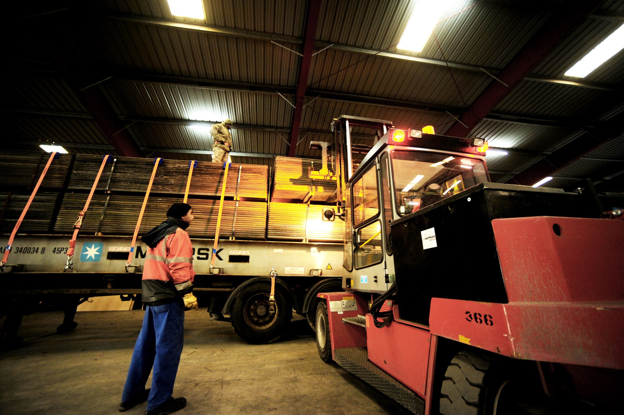 Air Force and local members of the Warehouses Service Agency load an AM-2 matt landing strip Feb. 22, 2010, at the Central Region Storage Facility, Sanem, District of Luxembourg, in support of ongoing war efforts. The Air Force members are from the 86th Material Maintenance Squadron, Ramstein Air Base, Germany. (U.S. Air Force photo by Tech. Sgt. Sarayuth Pinthong)