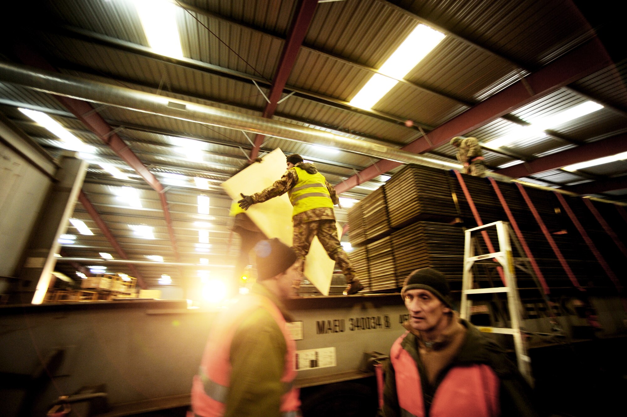 Air Force and local members of the Warehouses Service Agency load an AM-2 matt landing strip Feb. 22, 2010, at the Central Region Storage Facility, Sanem, District of Luxembourg, in support of ongoing war efforts. The Air Force members are from the 86th Material Maintenance Squadron, Ramstein Air Base, Germany. (U.S. Air Force photo by Tech. Sgt. Sarayuth Pinthong)