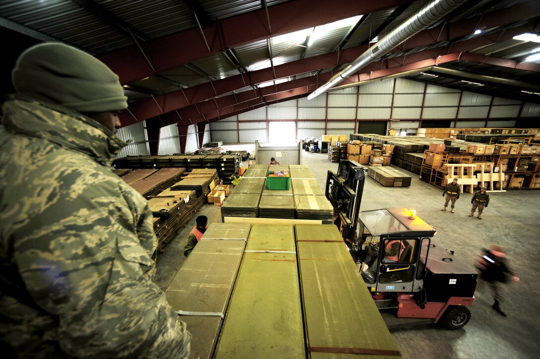 Tech. Sgt. Stevenson Johnson and local members of the Warehouses Service Agency loads an AM-2 matt landing strip Feb. 22, 2010 at the Central Region Storage Facility, Sanem, District of Luxembourg, in support of ongoing war efforts. Sergeant Johnson is from the 86th Material Maintenance Squadron, Ramstein Air Base, Germany. (U.S. Air Force photo by Tech. Sgt. Sarayuth Pinthong)
