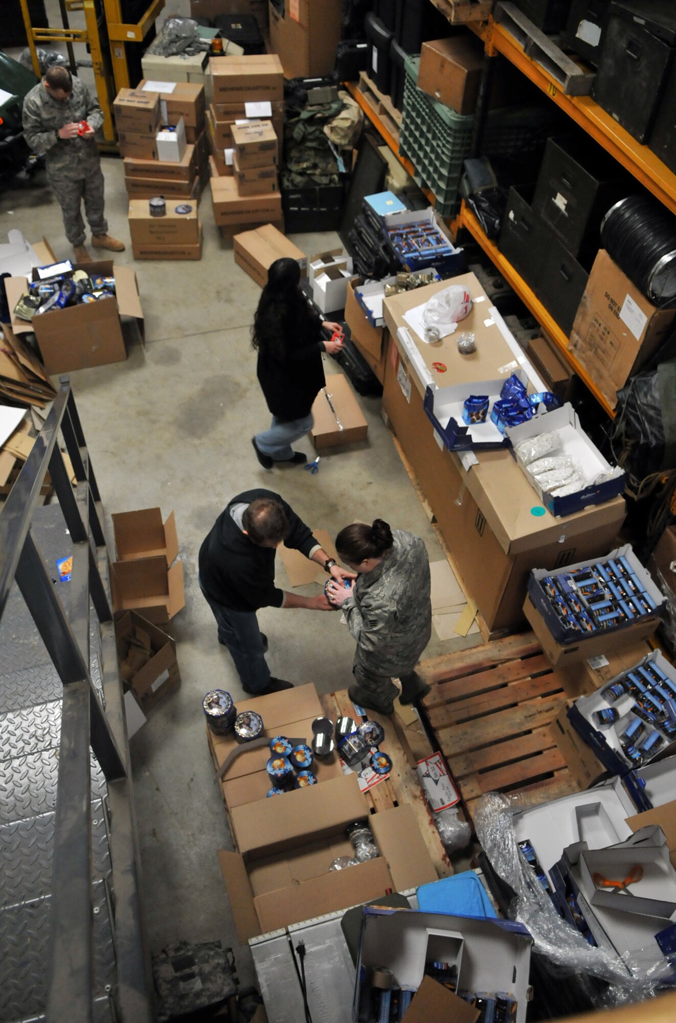 RAF MILDENHALL, England -- Volunteers prepare about 1,100 pounds of donated cookies to be sent to servicemembers deployed to the Middle East Feb. 26.  (U.S. Air Force photo by Staff Sgt. Austin M. May)