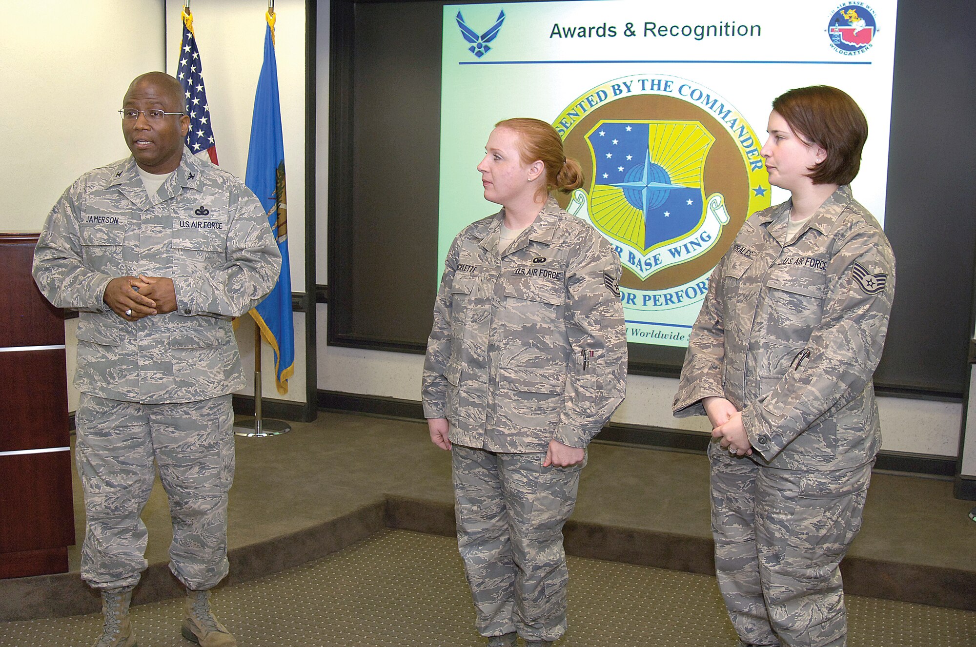 Col. Allen Jamerson, 72nd Air Base Wing and Tinker installation commander, presented commander’s coins to Staff Sgt. Lisa Vincellette and Staff Sgt. Jessica Corrales, two members of the Tinker Chapel team that earned Air Force Materiel Command awards. (Air Force photo by Margo Wright)