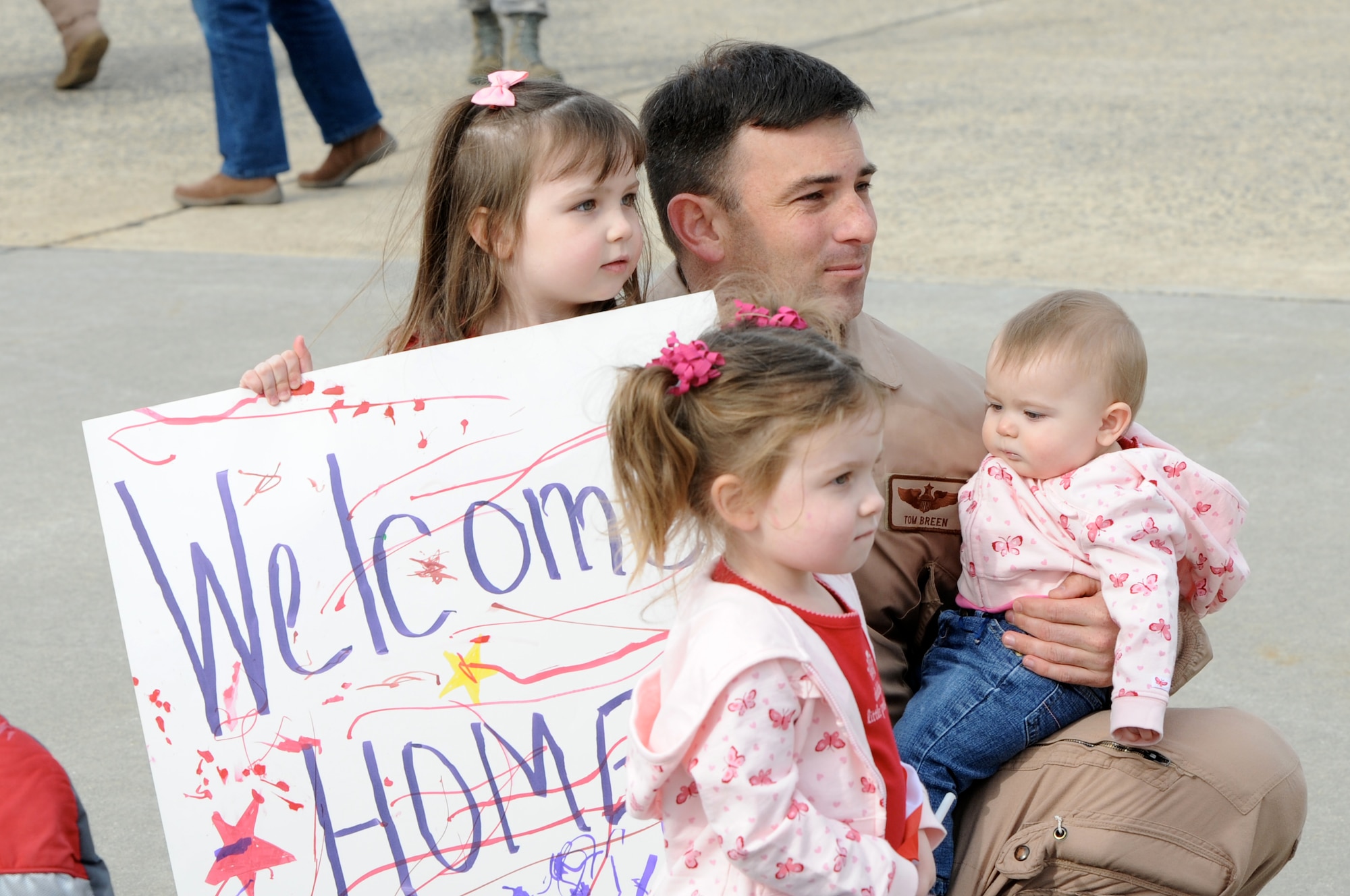 Maj Tom Breen, 6th AS C-17 Pilot, reunites with daughters (left-right) Nicole, Audrey and Tori, after a four-month deployment in support of Operations IRAQI AND ENDURING FREEDOM. (U.S. Air Force photo/Wayne Russell)
