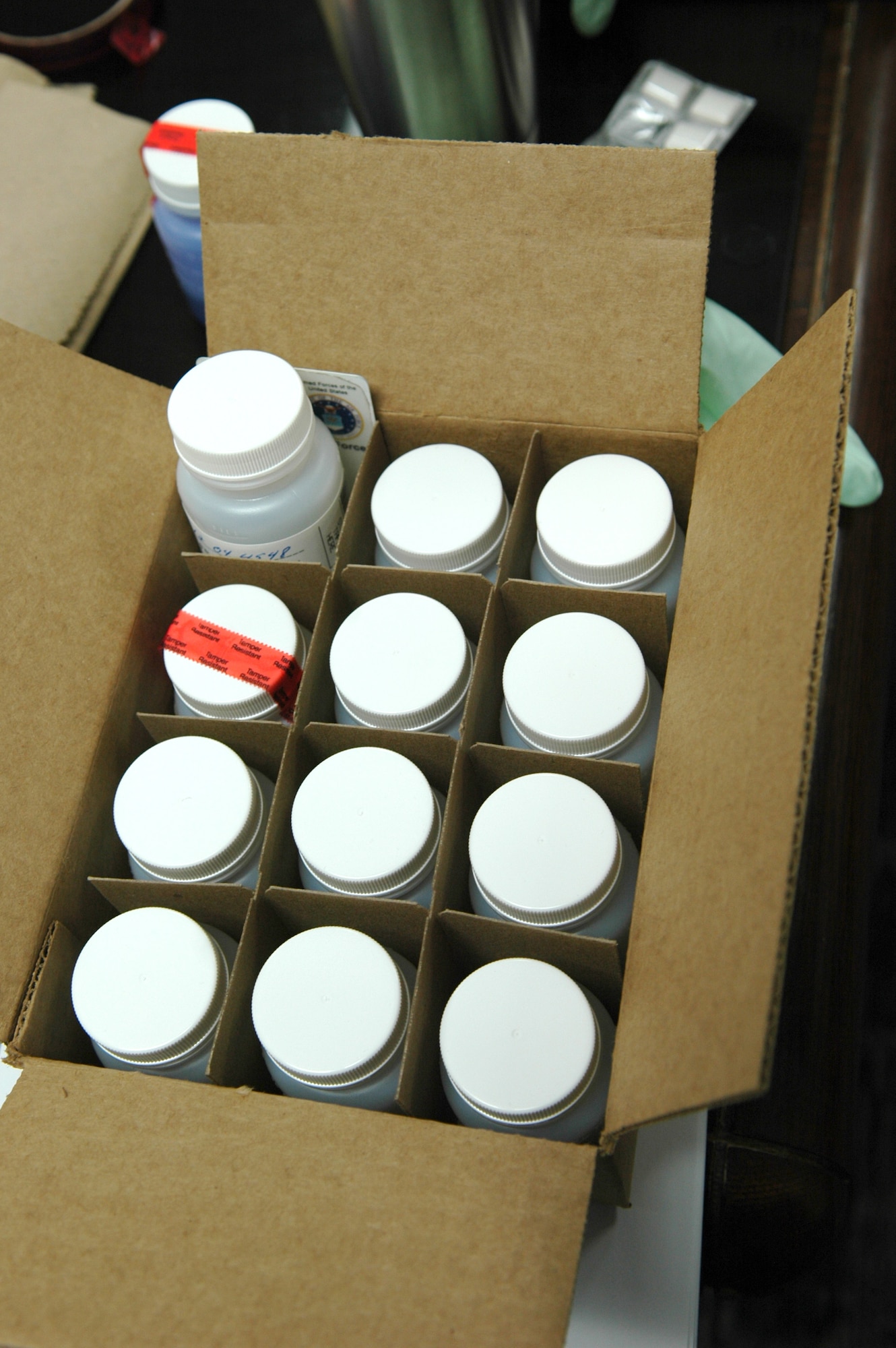Three members of the 72nd Medical Group Drug Demand Reduction program, along with 12 first sergeants were on hand to collect urine samples that would be tested for all kinds of drugs, including prescription medication. Once a servicemember was notified at the gate of the screening, they were not permitted to leave the area until their vehicles had been searched and they were able to provide a urine sample. (Air Force photo by Micah Garbarino)