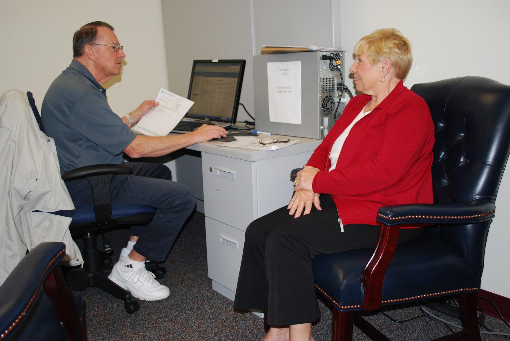 Volunteer Income Tax Assistance Program worker Don Winterich speaks with Ursula Aamodt about her tax return Wednesday in the Shark Center. Since opening four weeks ago, the center has served 433 clients and processed tax refunds worth more than $667,000. To make an appointment, call 494-4718. (U.S. Air Force photo/Senior Airman David Dobrydney)