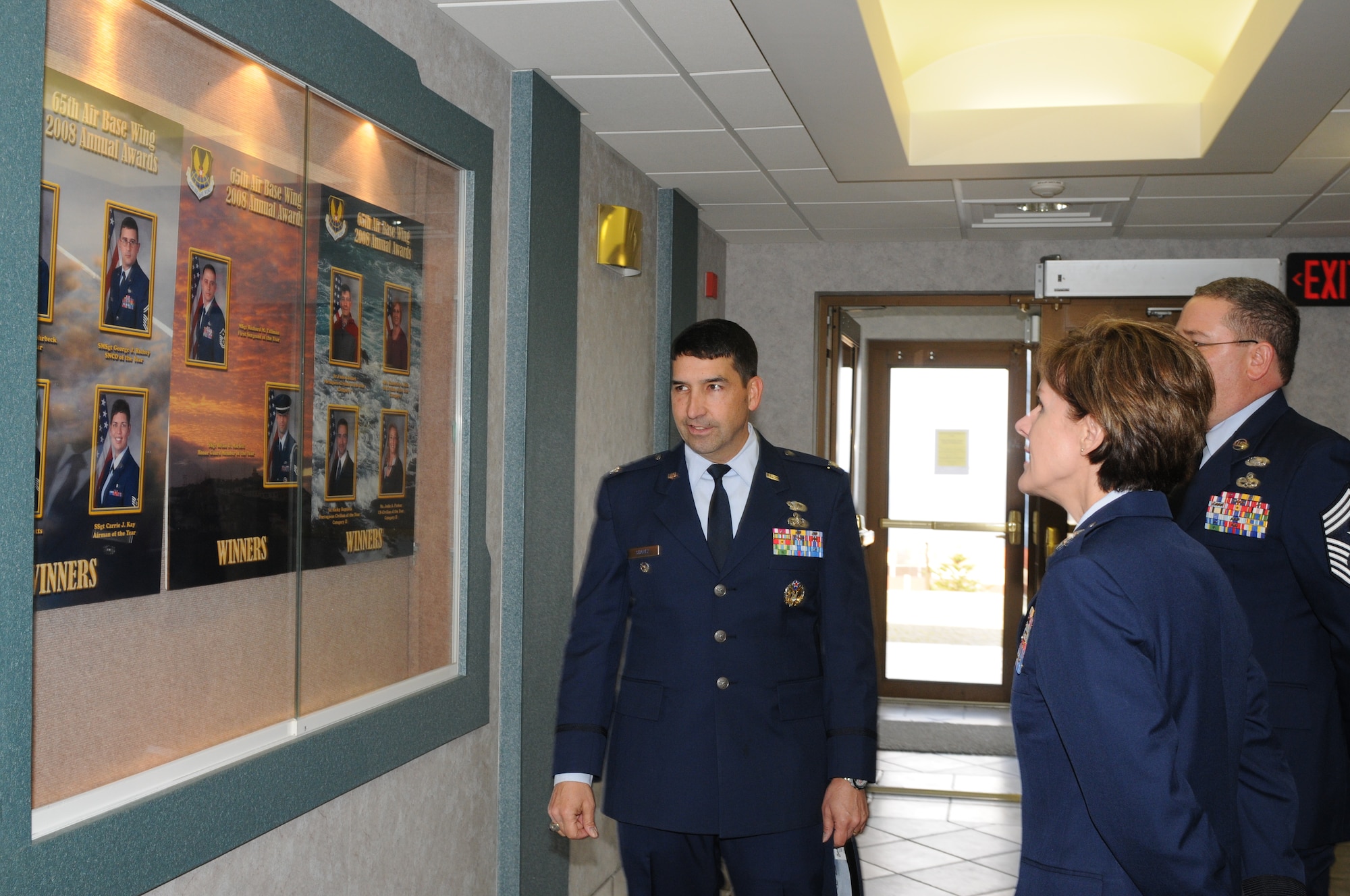 Col. Paul Suarez, 65th Air Base Wing vice commander, shows Maj. Gen. Judith A. Fedder, former 65th ABW commander, the wing hallway board displaying former award winners during her visit to see Airmen at Lajes Field, Azores.  General Fedder, the first female commander of the 65th ABW, was a guest speaker at the wing’s annual award ceremony held here. (U.S. Air Force photo/Guido Melo)