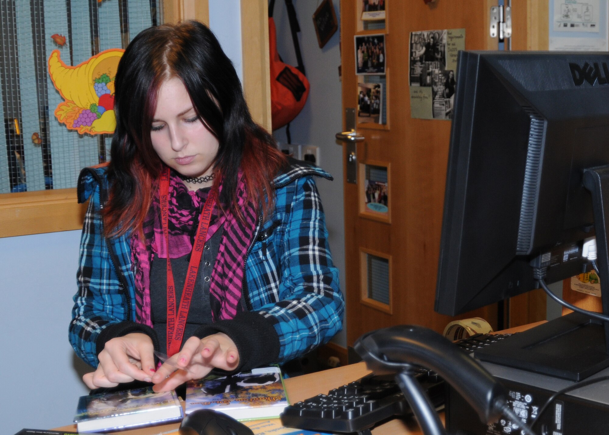 Franziska Christianson, Lakenheath High School senior, labels books at the Lakenheath Intermediate School library. The Career Practicum program at LHS gives seniors hands-on work experience in different workplaces. (U.S. Air Force photo/ Elysia Garcia) 