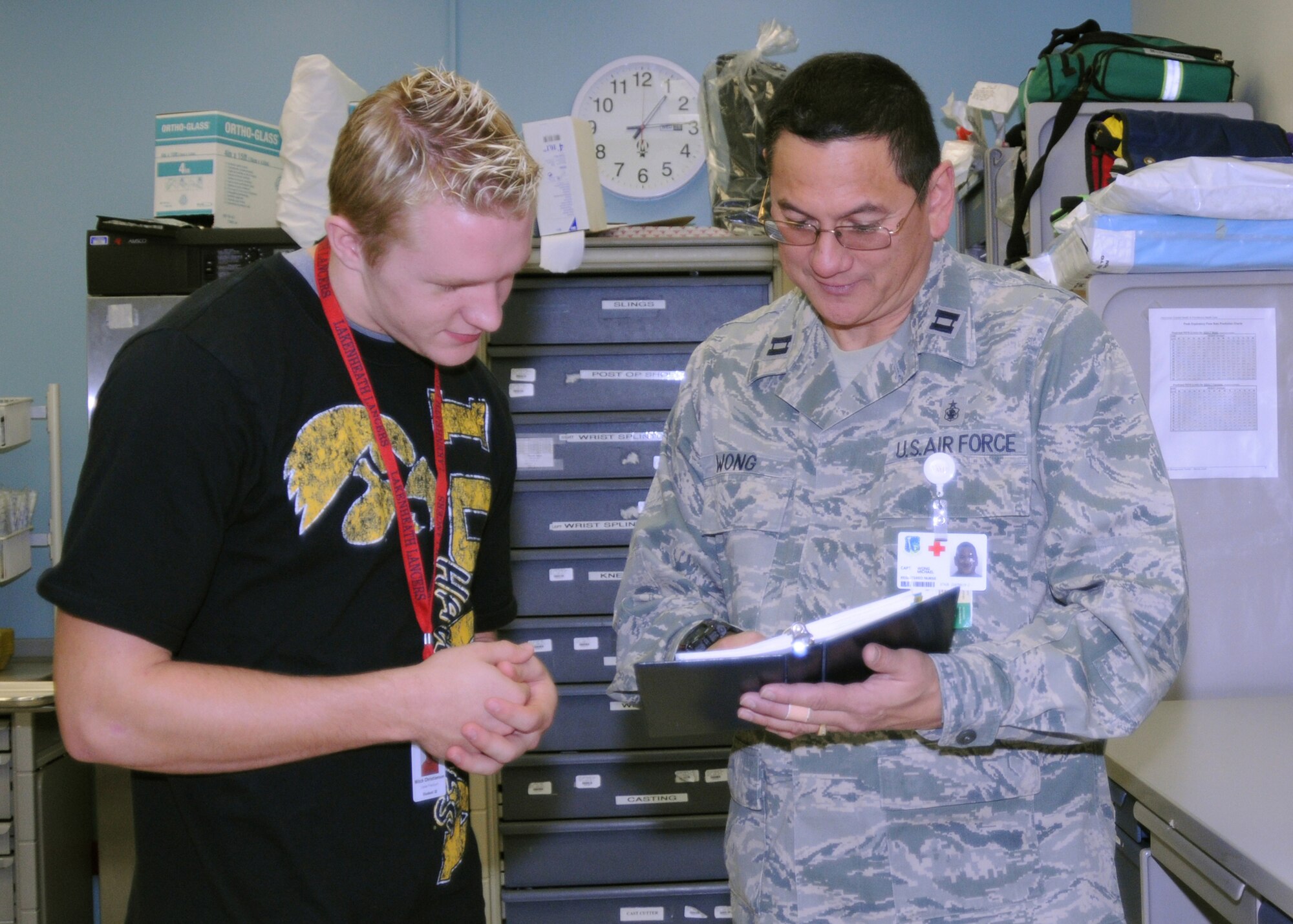 Captain Michael Wong, 48th Medical Operations Squadron staff nurse, shows Mitchell Christianson Lakenheath High School senior, how to properly treat a patient in the case of an allergic reaction. Christianson is enrolled in the Career Practicum program available at LHS, gaining both work experience and valuable skills for the future. (U.S. Air Force photo/ Elysia Garcia) 