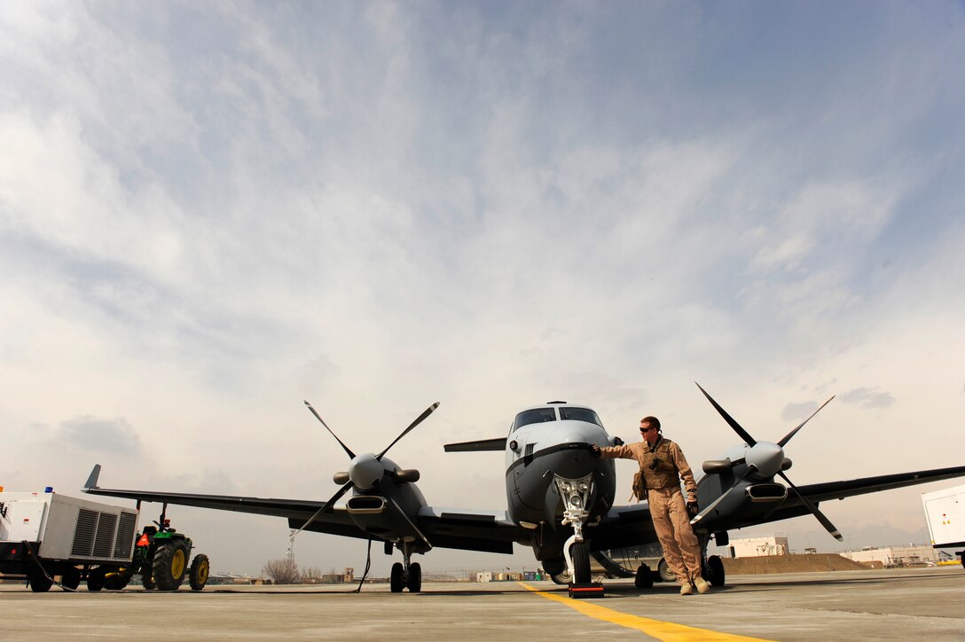 Lt. Col. Douglas J. Lee, 4th Expeditionary Reconnaissance Squadron commander, performs a walk-around inspection of an MC-12W prior to boarding it for a mission, Feb. 27, 2010, at Bagram Airfield, Afghanistan.  The MC-12 program was dubbed the Project Liberty Program as a nod to a World War II effort that quickly built and transitioned commercial ships to the fight in Europe, much like how the Air Force fielded  the MC-12.  (U.S. Air Force photo/Staff Sgt. Manuel J. Martinez/released)






