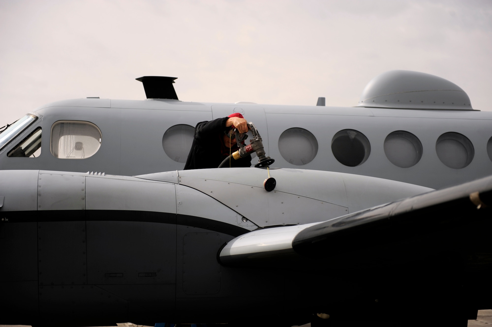 John Marshall, a 4th Expeditionary Reconnaissance Squadron MC-12W Liberty maintainer, refuels an MC-12W aircraft Feb. 27, 2010, at Bagram Airfield, Afghanistan. (U.S. Air Force photo/Staff Sgt. Manuel J. Martinez/released)