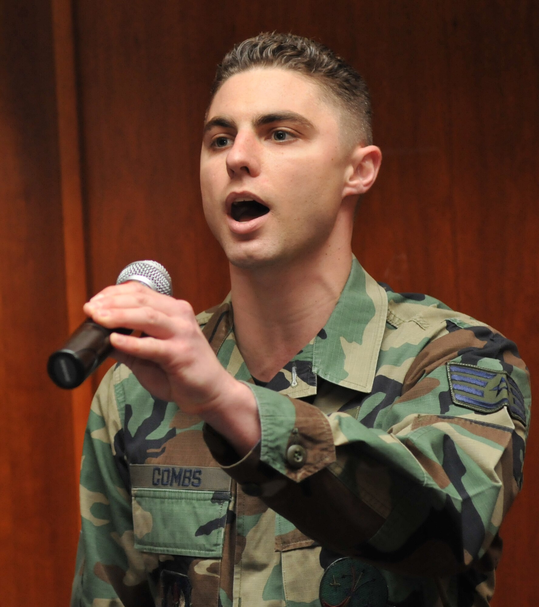 SPANGDAHLEM AIR BASE, Germany – Staff Sgt. Adam Combs sings the National Anthem during the 2009 Maintenance Professional of the Year awards banquet Feb. 27 at Club Eifel. The banquet highlighted the 52nd Maintenance Group’s accomplishments including engine and hydrazine support throughout Europe, taking part in several Air Force Smart Operation initiatives, and completing numerous aircraft and equipment upgrades and modifications. They also supported more than 10,000 homestation sorties and 28,000 flying hours, culminating in recognition as the best maintenance group in U. S. Air Forces in Europe and winning the command’s 2009 Daedalian trophy. (U.S. Air Force photo/Airman 1st Class Nick Wilson)