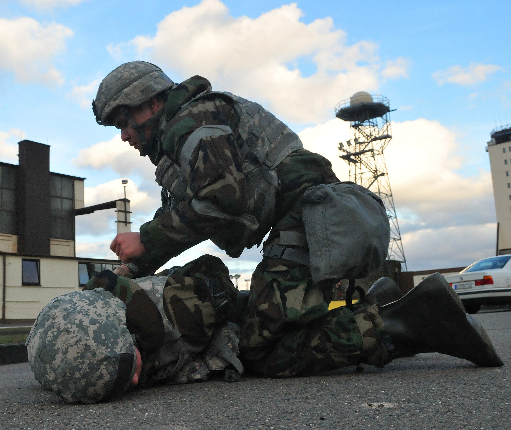 SPANGDAHLEM AIR BASE, Germany – Airman 1st Class Lenjie Olbrantz, 52nd Security Forces Squadron, arrests Senior Airman Geoffrey Witter, 52nd SFS, after Airman Witter simulated abandoning his post during Operation Saber Crown 10-04 here March 1. Airman Witter was instructed by members of the Exercise Evaluation Team to abandon his post to test the other security forces members. Members of the 52nd Fighter Wing participated in the Phase II exercise to evaluate the wing’s ability to survive and operate in a chemical, biological, radiological, nuclear and explosive environment. (U.S. Air Force photo/Airman 1st Class Nick Wilson)