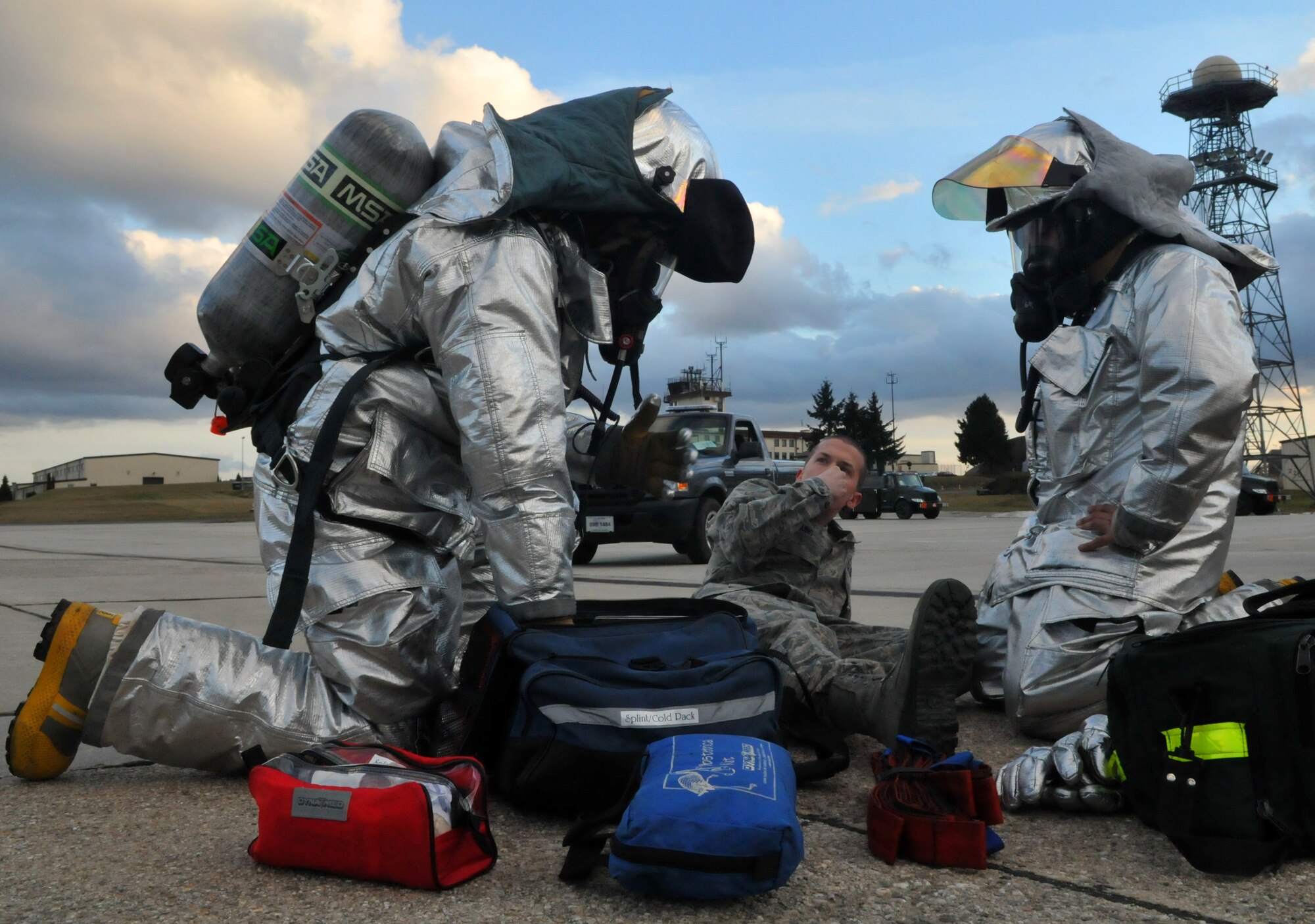 SPANGDAHLEM AIR BASE, Germany – 52nd Civil Engineer Squadron firefighters provide self-aid and buddy care to Airman 1st Class Michael King, 52nd Component Maintenance Squadron egress journeyman, after a simulated car accident during Operation Saber Crown 10-04 here March 1. Members of the 52nd Fighter Wing participated in the Phase II exercise to evaluate the wing’s ability to survive and operate in a chemical, biological, radiological, nuclear and explosive environment. (U.S. Air Force photo/Airman 1st Class Nick Wilson)