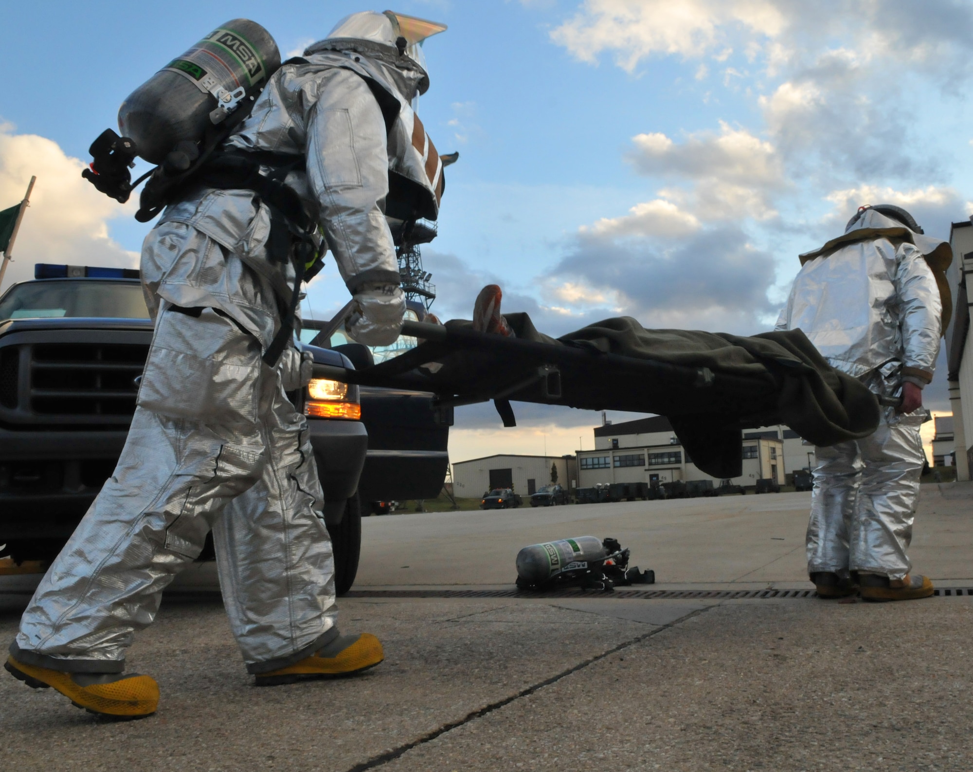 SPANGDAHLEM AIR BASE, Germany – 52nd Civil Engineer Squadron firefighters carry a moulage victim to safety on a stretcher after a simulated car accident during Operation Saber Crown 10-04 here March 1. Members of the 52nd Fighter Wing participated in the Phase II exercise to evaluate the wing’s ability to survive and operate in a chemical, biological, radiological, nuclear and explosive environment. (U.S. Air Force photo/Airman 1st Class Nick Wilson)
