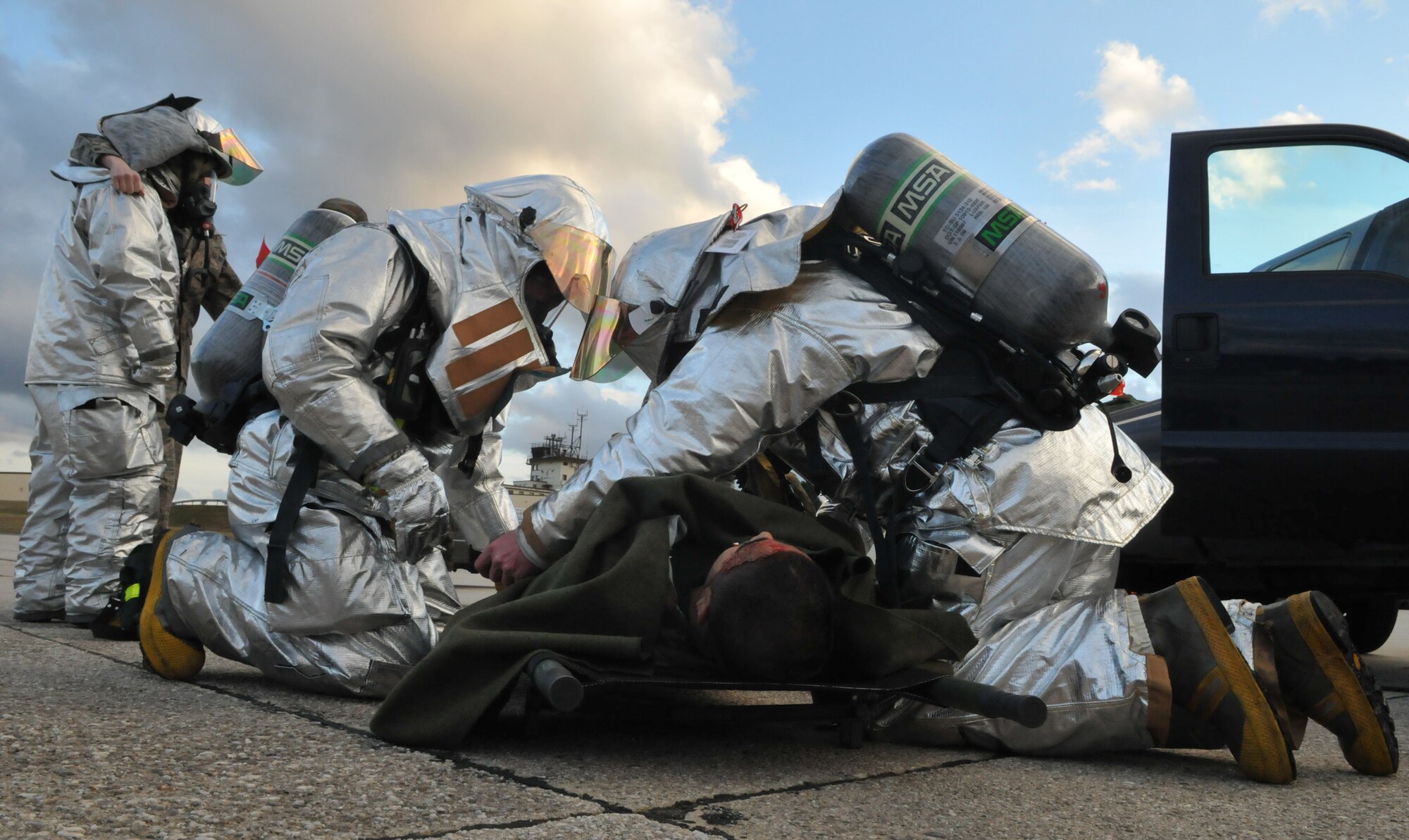 SPANGDAHLEM AIR BASE, Germany – 52nd Civil Engineer Squadron firefighters provide self-aid and buddy care to injured “victims” after a simulated car accident during Operation Saber Crown 10-04 here March 1. Members of the 52nd Fighter Wing participated in the Phase II exercise to evaluate the wing’s ability to survive and operate in a chemical, biological, radiological, nuclear and explosive environment. (U.S. Air Force photo/Airman 1st Class Nick Wilson)