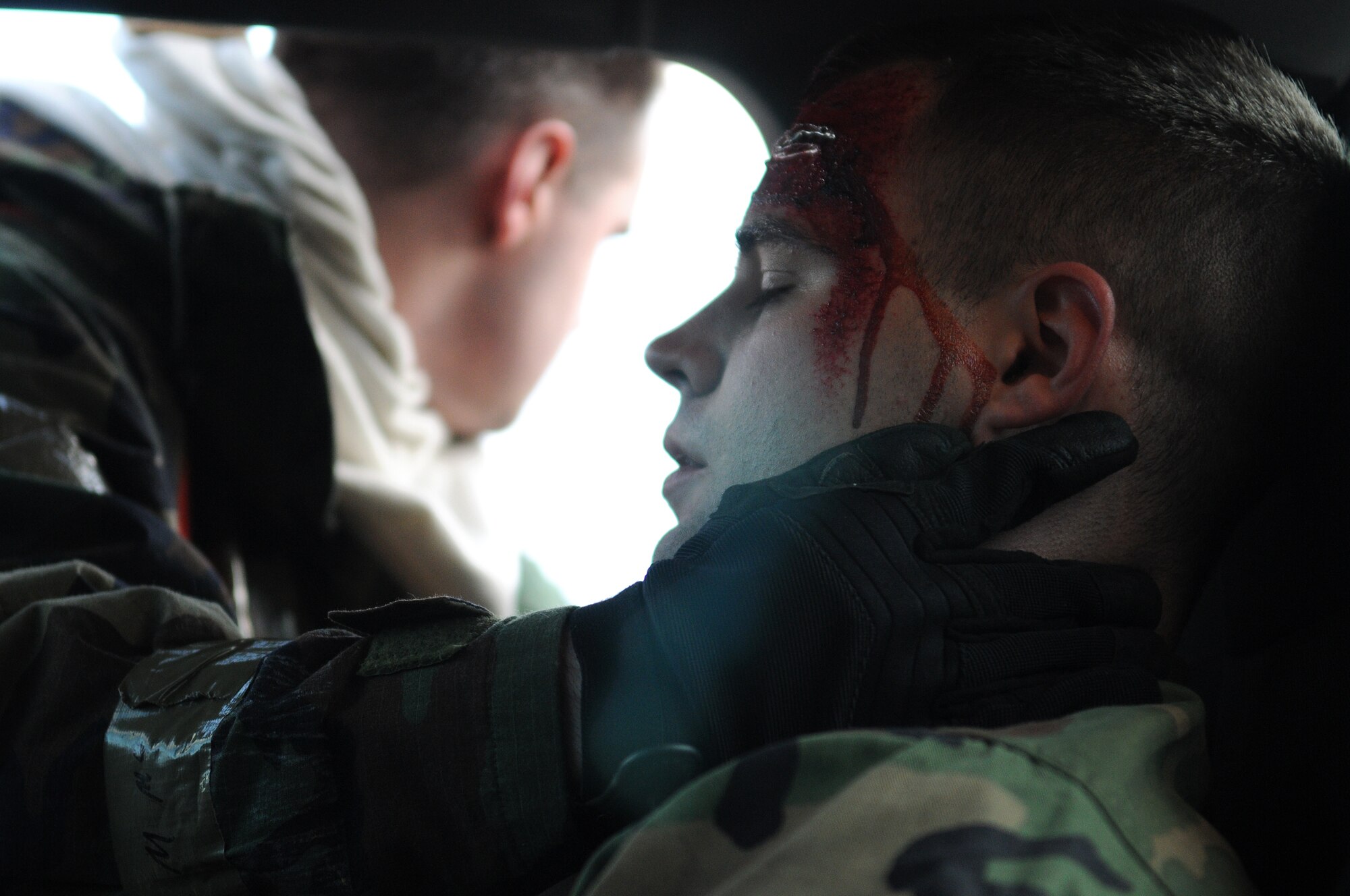 SPANGDAHLEM AIR BASE, Germany – Airman 1st Class Steven Ferguson, 52nd Force Support Squadron, waits patiently while Staff Sgt. Jordan Gren, 52nd Civil Engineer Squadron firefighter, stabilizes his patient after a simulated car accident during Operation Saber Crown 10-04 here March 1. Members of the 52nd Fighter Wing participated in the Phase II exercise to evaluate the wing’s ability to survive and operate in a chemical, biological, radiological, nuclear and explosive environment. (U.S. Air Force photo/Senior Airman Nathanael Callon)