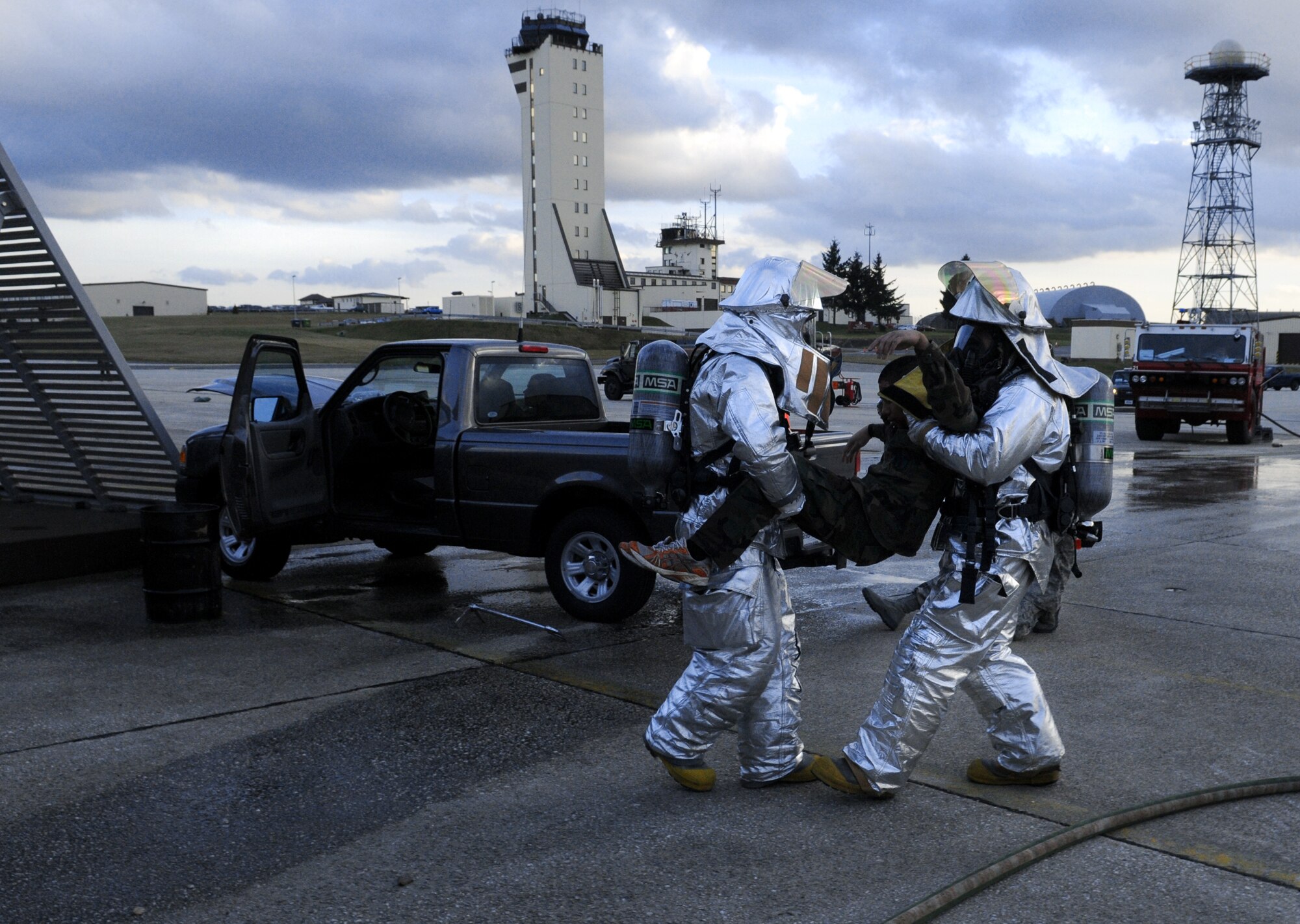 SPANGDAHLEM AIR BASE, Germany – Firefighters from the 52nd Civil Engineer Squadron Fire Department transport a victim after a simulated car accident during Operation Saber Crown 10-04 here March 1. Members of the 52nd Fighter Wing participated in the Phase II exercise to evaluate the wing’s ability to survive and operate in a chemical, biological, radiological, nuclear and explosive environment. (U.S. Air Force photo/Senior Airman Nathanael Callon)