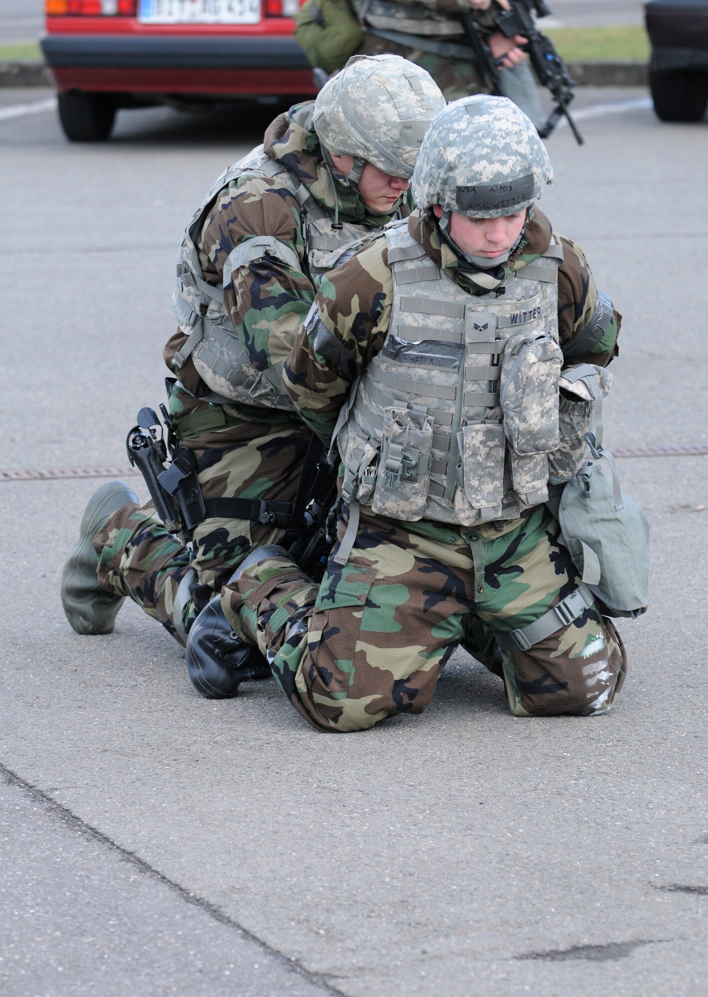 SPANGDAHLEM AIR BASE, Germany – Airman 1st Class Lenjie Olbrantz, 52nd Security Forces Squadron, arrests Senior Airman Geoffrey Witter, 52nd SFS, after Airman Witter simulated abandoning his post during Operation Saber Crown 10-04 here March 1. Airman Witter was instructed by members of the Exercise Evaluation Team to abandon his post to test the other security forces members. Members of the 52nd Fighter Wing participated in the Phase II exercise to evaluate the wing’s ability to survive and operate in a chemical, biological, radiological, nuclear and explosive environment. (U.S. Air Force photo/Senior Airman Nathanael Callon)