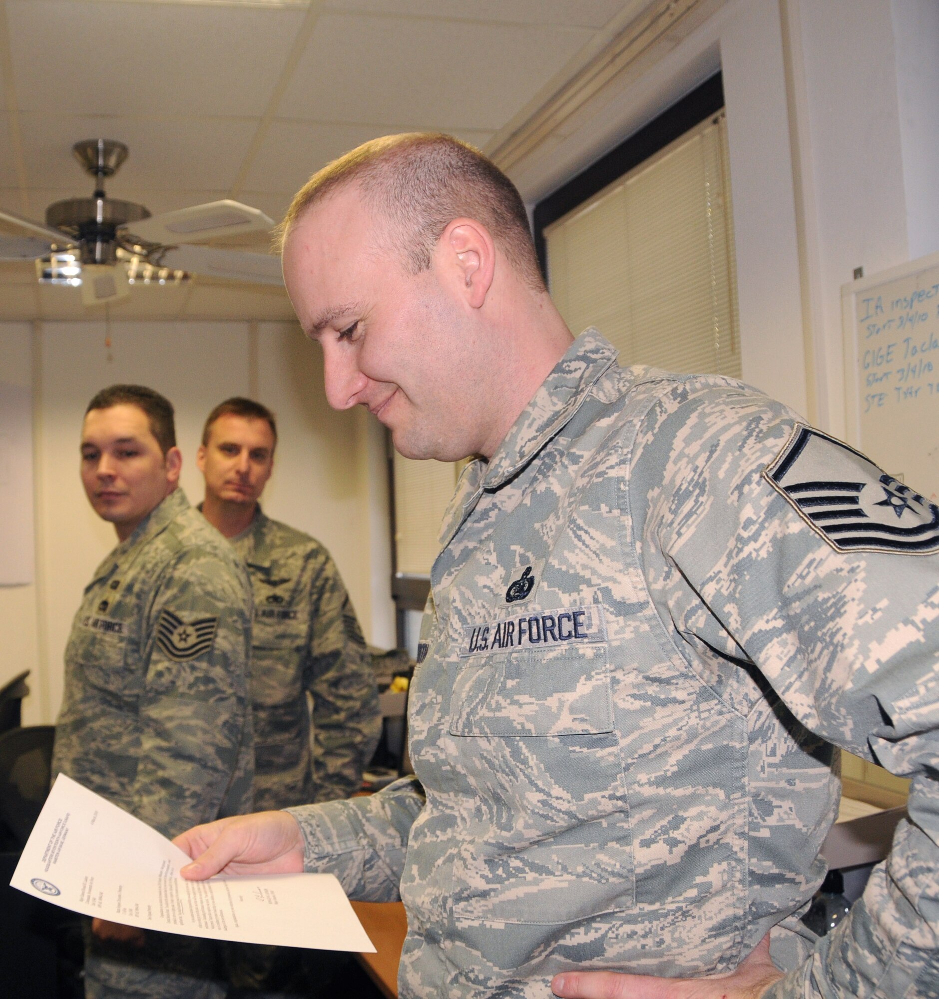 RAMSTEIN AIR BASE, Germany – Senior Master Sgt. (select) Christopher Penberthy, 17th Air Force manager of capabilities and integration, learns about his selection to E-8 by reading a congratulatory memo handed to him by Maj. Gen. Ronald Ladnier, 17th AF commander, March 5. Six master sergeants from 17th AF were selected for promotion to senior master sergeant. (U.S. Air Force photo by Staff Sgt. Stefanie Torres) 