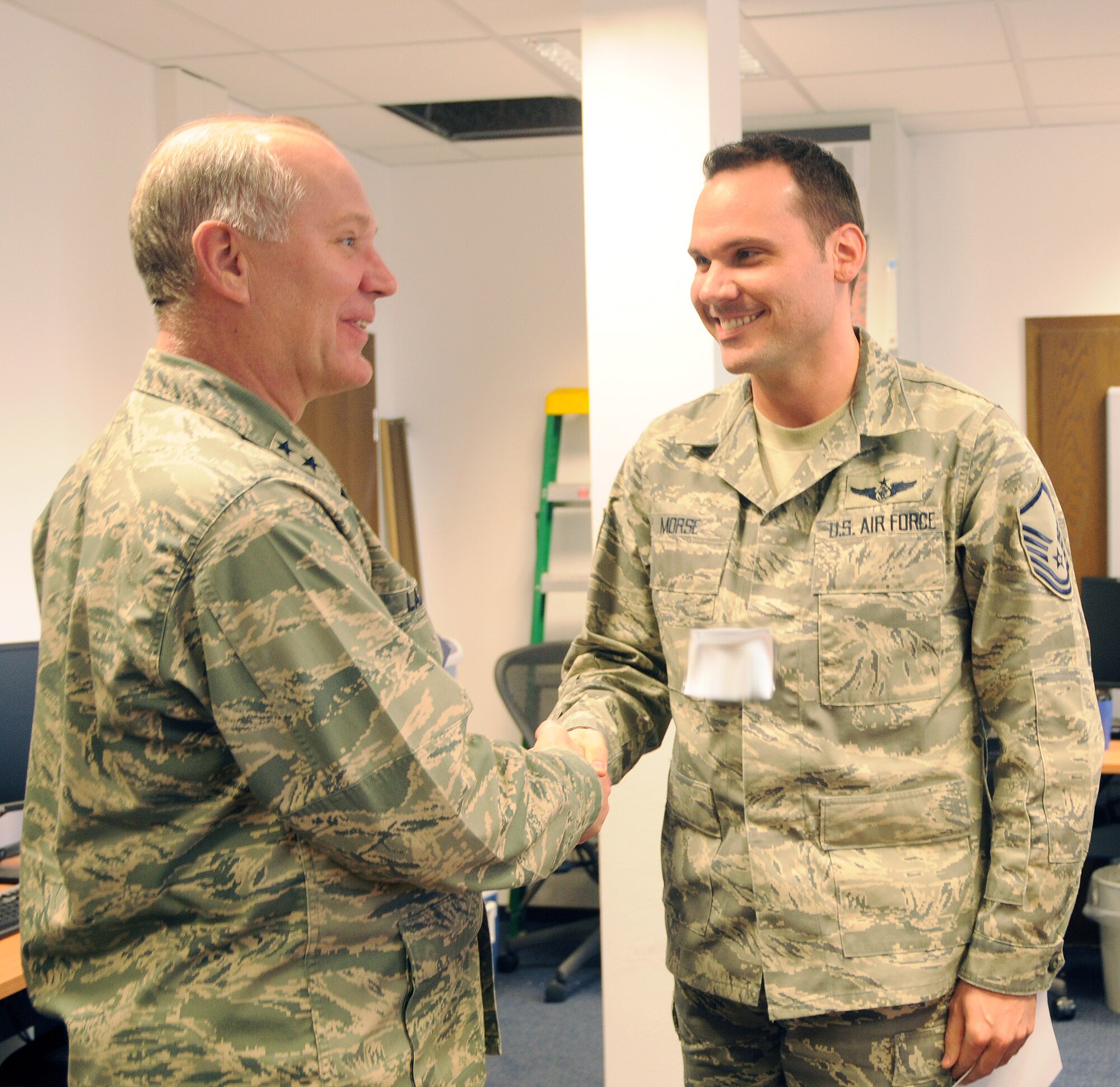 RAMSTEIN AIR BASE, Germany – Maj. Gen. Ronald Ladnier, 17th Air Force commander, congratulates Senior Master Sgt. (select) David Morse on his selection for promotion March 4. Sergeant Morse is the 617th Air and Space Operations Center NCO in charge of the Air Mobility Division. Six master sergeants from 17th AF were selected for promotion to senior master sergeant. (U.S. Air Force photo by Staff Sgt. Stefanie Torres)