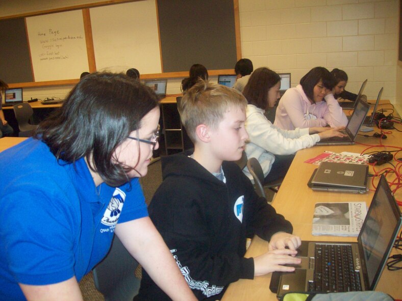 Teacher Allison Fenimore works on a science project with student Zach Somers at Osan Middle School. (Photo/Dr. Jennifer Smith)