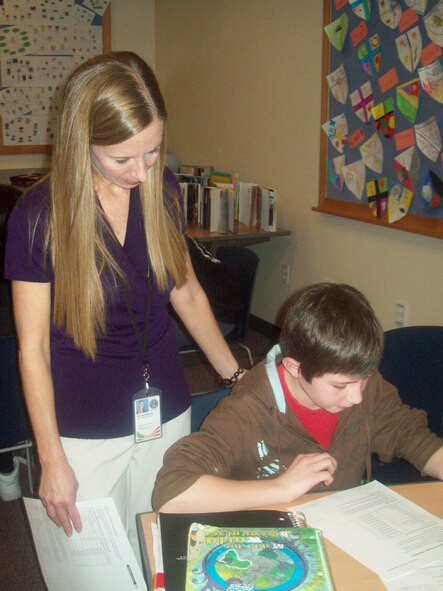 Instructional assistant, and parent, Brenda Massey monitors student Jake Harold in his social studies class at Osan Middle School. (Photo/Dr. Jennifer Smith)
