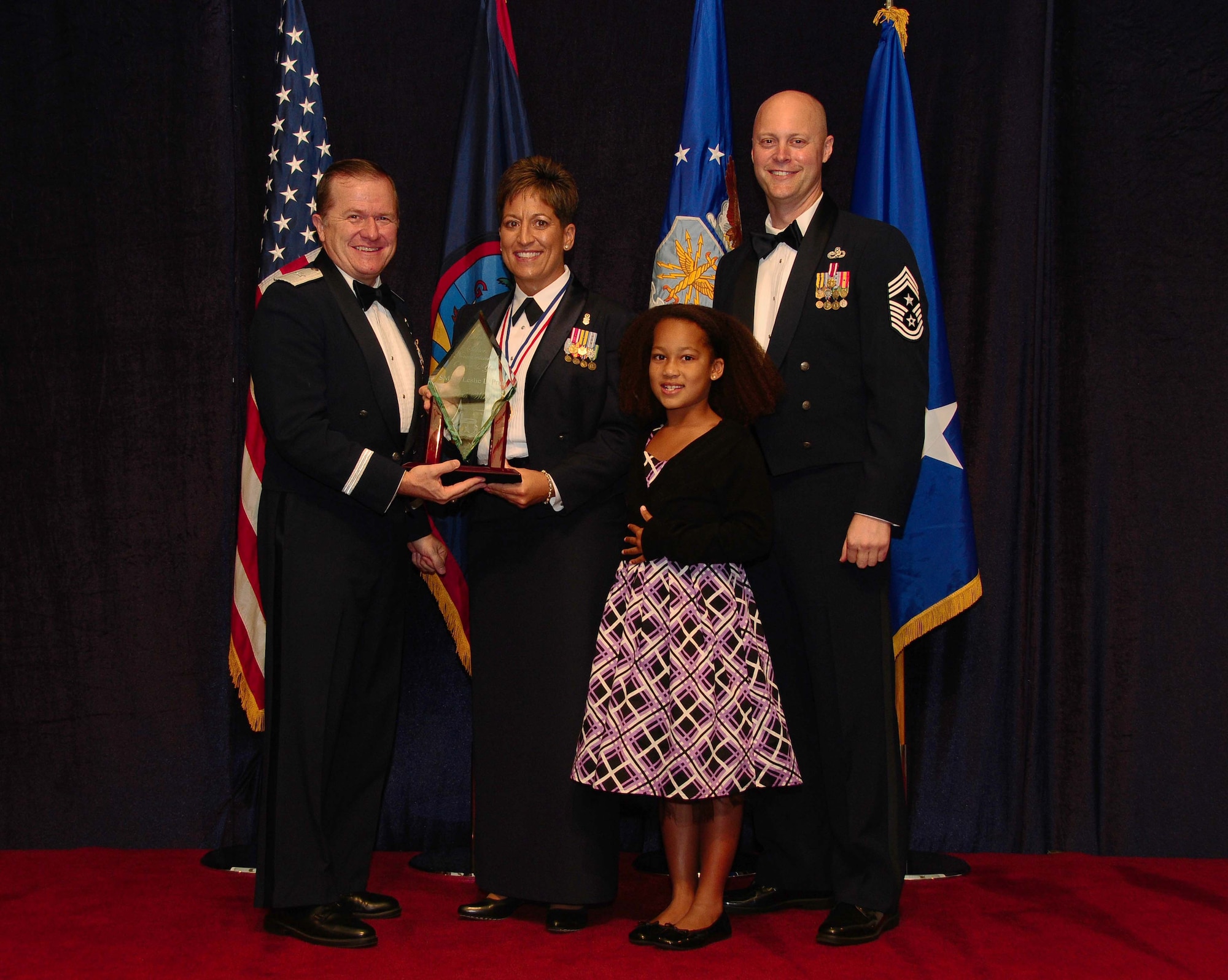 ANDERSEN AIR FORCE BASE, Guam - Senior Non Comissioned Officer of the Year winner Senior Master Sgt. Leslie Pratt, 36th Medical Group, is congratulated by Brig. Gen. Phil Ruhlman, Commander, 36th Wing, and Command Chief Master Sgt. Allen Mullinex during the Feb. 19 Annual Award ceremony.( U.S. Air Force photo by Airman 1st Class Jeffrey Schultze)