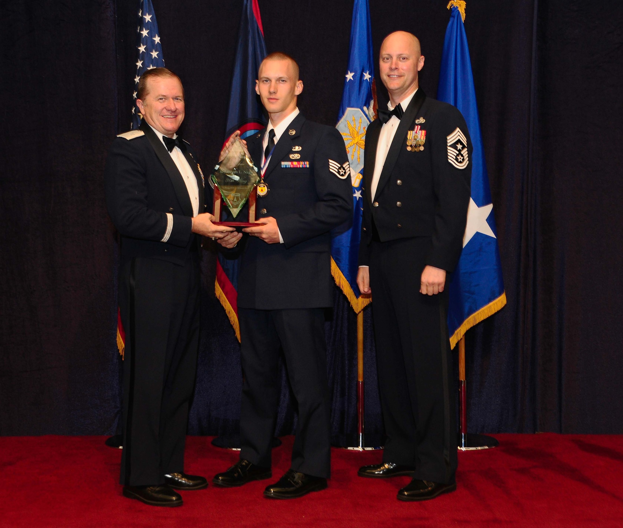 ANDERSEN AIR FORCE BASE, Guam - Airman of the Year winner Senior Amn. Bryan Nagy,  36th Contingency Response Group, is congratulated by Brig. Gen. Phil Ruhlman, Commander, 36th Wing, and Command Chief Master Sgt. Allen Mullinex during the Feb. 19 Annual Award ceremony.( U.S. Air Force photo by Airman 1st Class Jeffrey Schultze)
