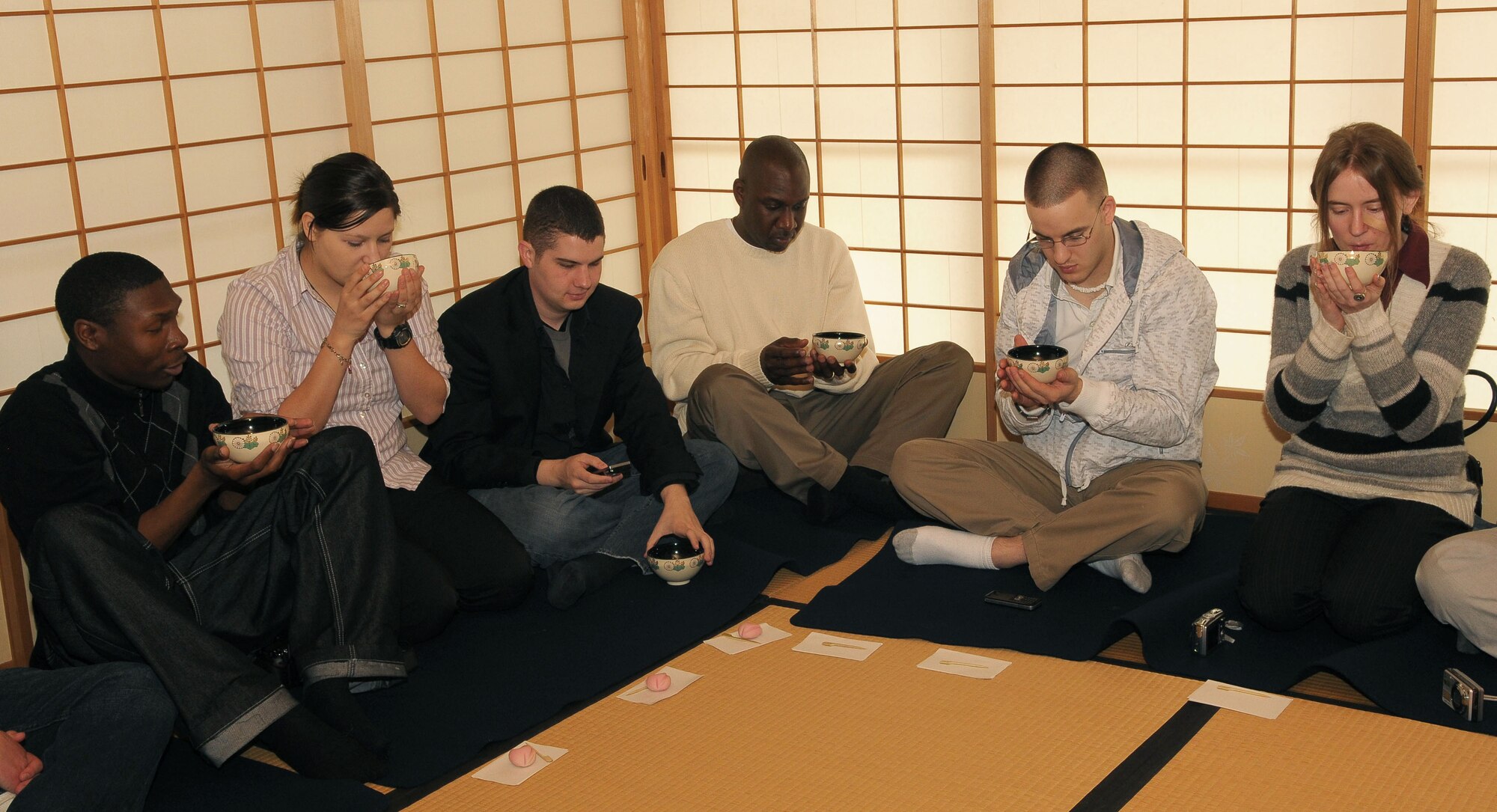 TACHIKAWA, Japan -- Members of Yokota Air Base, drink traditional Japanese green tea Mar. 3 during a tour through the Japanese Garden at Showa Kinen Park.  Park managers hosted the group of military and civilian residents of Yokota, to help them experience authentic Japanese culture. The Japanese government created Showa Park 1983 to commemorate the 50th anniversary of Emperor Showa's reign.  (U.S. Air Force photo/Airman 1st Class Sean Martin)