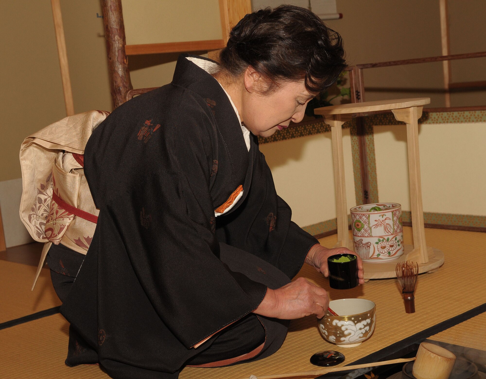 TACHIKAWA, Japan -- Reiko Kobayashi, an employee at the Japanese Garden, prepares to make traditional Japanese green tea Mar. 3 during a tour through the Japanese Garden at Showa Kinen Park. Park managers hosted the group of military and civilian residents of Yokota, to help them experience authentic Japanese culture. The Japanese government created Showa Park 1983 to commemorate the 50th anniversary of Emperor Showa's reign. (U.S. Air Force photo/Airman 1st Class Sean Martin)