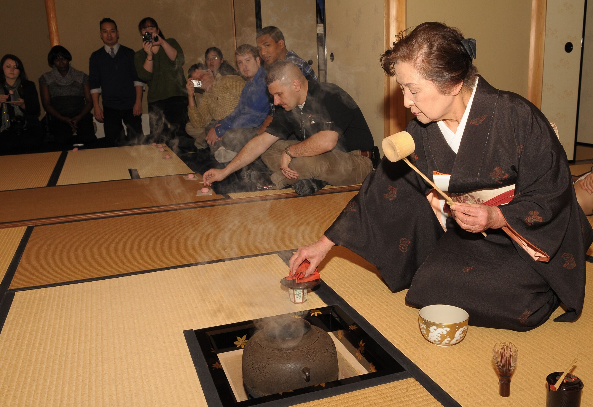 TACHIKAWA, Japan -- Reiko Kobayashi, an employee at the Japanese Garden, makes traditional Japanese green tea Mar. 3 during a tour through the Japanese Garden at Showa Kinen Park. Park managers hosted the group of military and civilian residents of Yokota, to help them experience authentic Japanese culture. The Japanese government created Showa Park 1983 to commemorate the 50th anniversary of Emperor Showa's reign. (U.S. Air Force photo/Airman 1st Class Sean Martin)