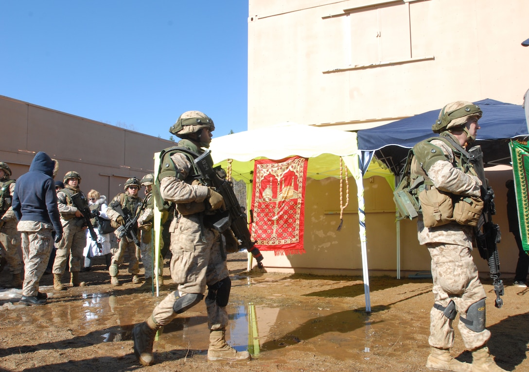 U.S. Marine lieutenants stand guard as perimeter security during a mock patrol operation training exercise at the Military Operations in Urban Terrain Training Center, Camp Barrett, on Marine Corps Base Quantico, Va., March 4, 2010. 