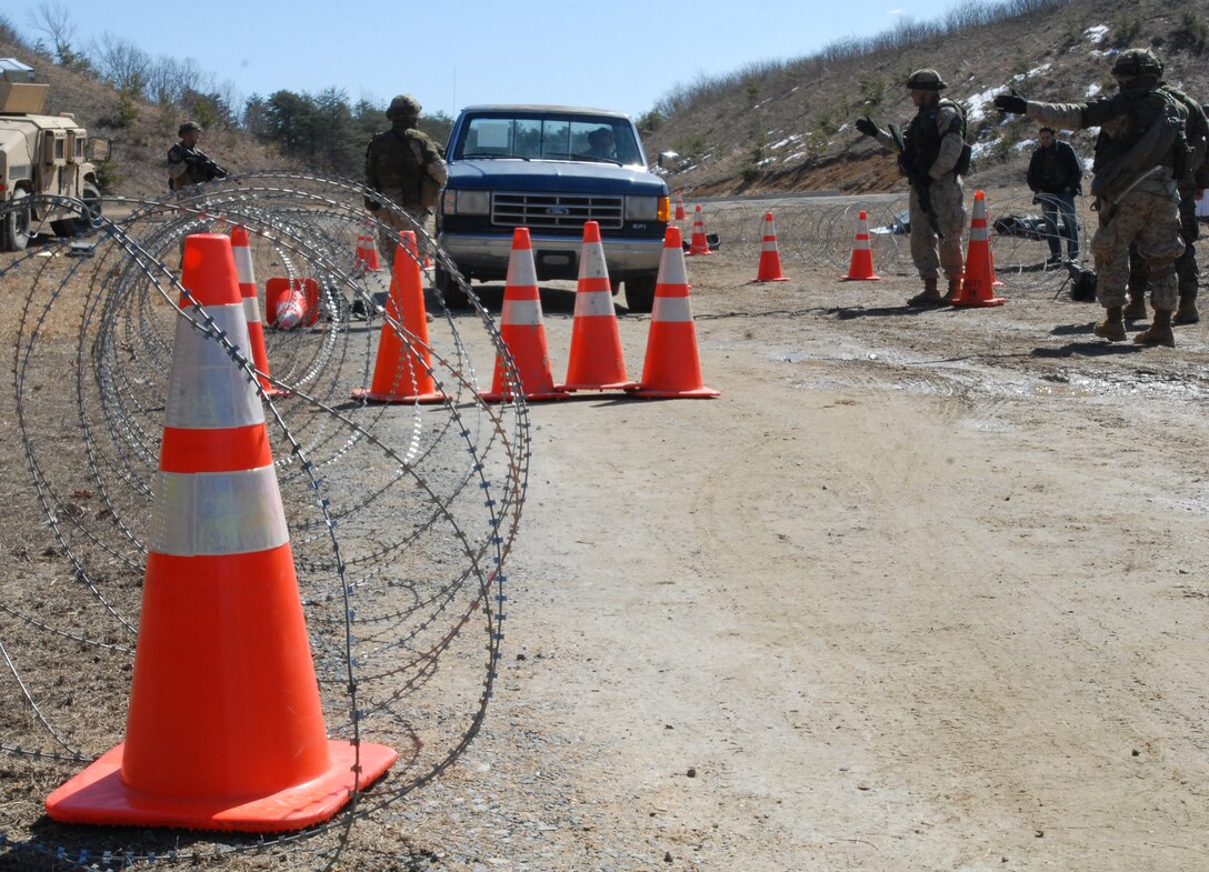 U.S. Marine lieutenants stop a pickup truck at a mock vehicle inspection checkpoint during training exercises at the Military Operations in Urban Terrain Training Center, Camp Barrett, on Marine Corps Base Quantico, Va., March 4, 2010. 