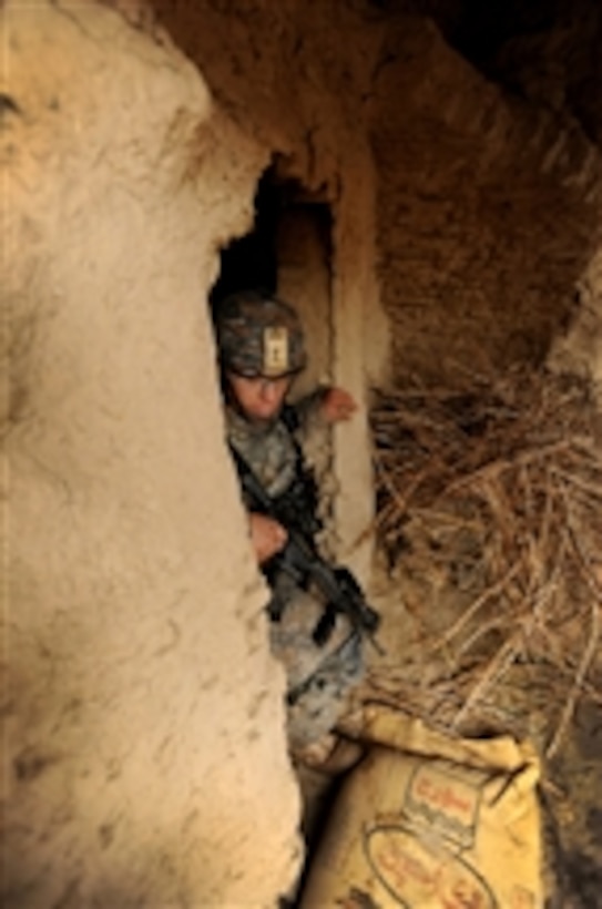 U.S. Army 1st Lt. Matt Jarmon, assigned to Charlie Company, 82nd Airborne Division, exits a compound after performing a search at a village in southern Afghanistan on Feb. 5, 2010.  The U.S. Army and Canadian Forces Land Force Command are helping the Afghan National Army clear several villages of improvised explosive devices, weapons caches and illegal drugs.  