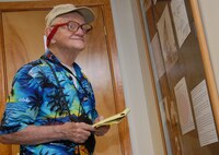 ANDERSEN AIR FORCE BASE, Guam - Cyril O'Brian, a veteran of the battle of Iwo Jima, takes notes during a visit to the Heritage Museum here on March 1.  O'Brian was a combat correspondent on Iwo Jima and Guam during World War II and is touring the area during the 65th anniversary of Iwo Jima.  (U.S. Air Force photo by Staff Sgt. Jamie Lessard)