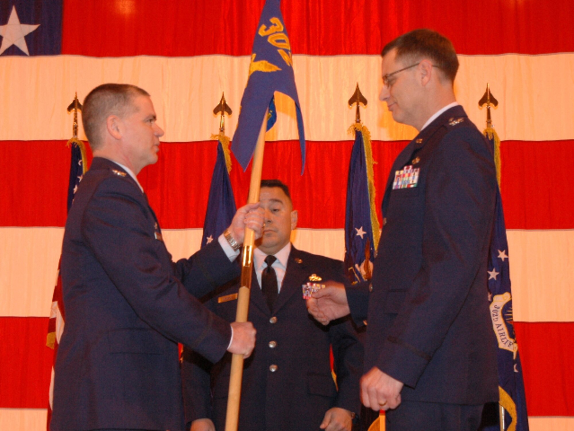 Col. James Van Housen (right) prepares to accept the 302nd Maintenance Group guidon from Col. Jay Pittman, Jr. (left) March 6 while accepting command of the group at Peterson Air Force Base, Colo. Colonel Van Housen assumed command of the group in front of an audience of more than 120 people. Colonel Van Housen assumed command of the group after Col. Mark Rodriguez departed the 302nd MXG to become the maintenance liaison officer for 10th Air Force, based at Naval Air Station Joint Reserve Base Fort Worth, Texas. (U.S. Air Force photo/Staff Sgt. Stephen J. Collier)