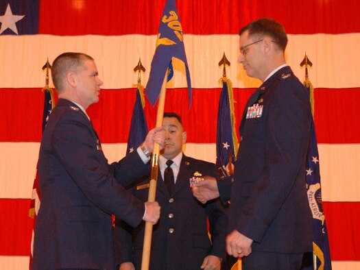 Col. James Van Housen (right) prepares to accept the 302nd Maintenance Group guidon from Col. Jay Pittman, Jr. (left) March 6 while accepting command of the group at Peterson Air Force Base, Colo. Colonel Van Housen assumed command of the group in front of an audience of more than 120 people. Colonel Van Housen assumed command of the group after Col. Mark Rodriguez departed the 302nd MXG to become the maintenance liaison officer for 10th Air Force, based at Naval Air Station Joint Reserve Base Fort Worth, Texas. (U.S. Air Force photo/Staff Sgt. Stephen J. Collier)